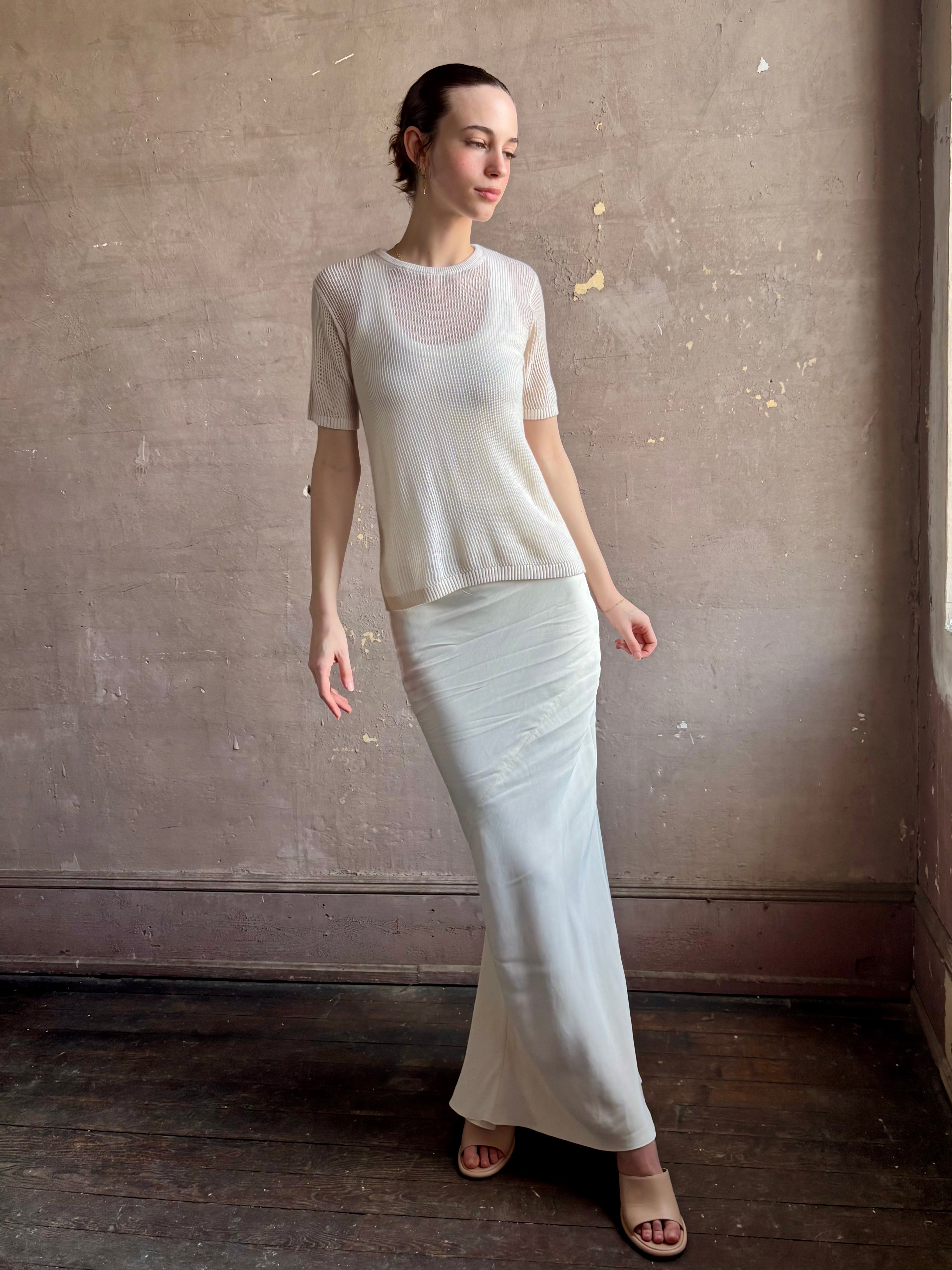 Woman wearing luxury designer TWP Short Sleeve premium knit lightweight cashmere Tee top in Ivory with crew neck and short sleeves