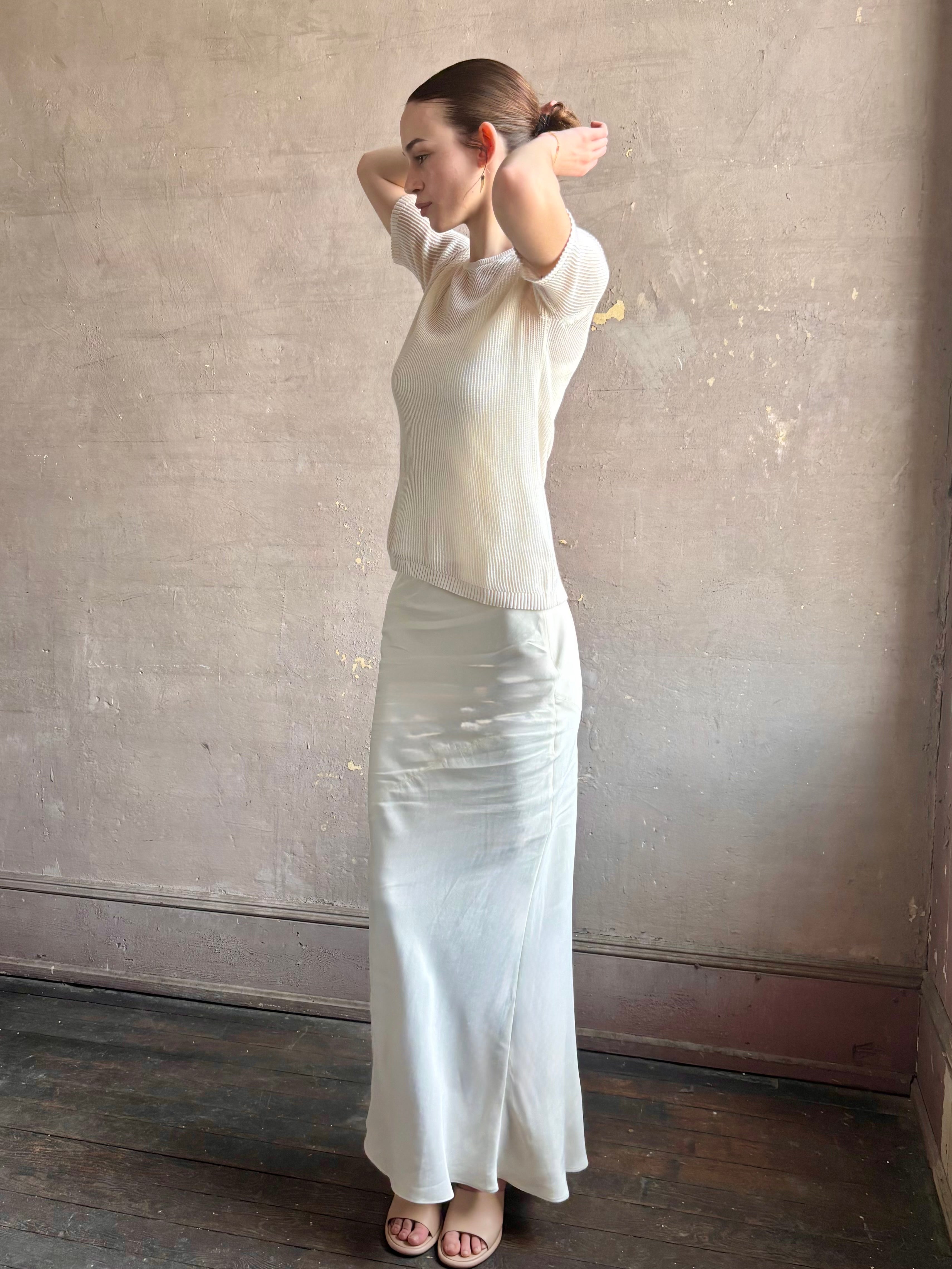 Woman wearing luxury designer TWP Short Sleeve premium knit lightweight cashmere Tee top in Ivory with crew neck and short sleeves