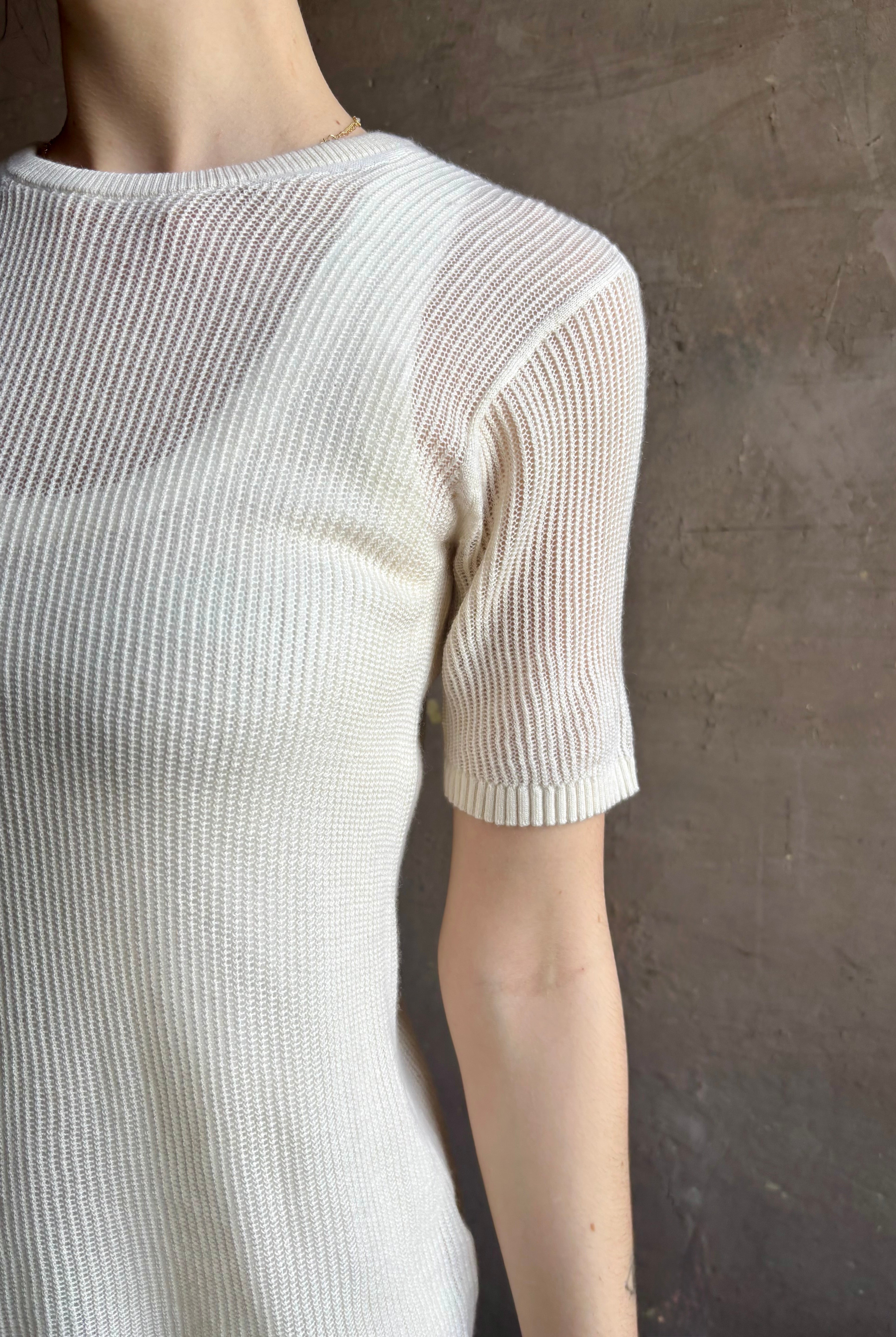 Woman wearing luxury designer TWP Short Sleeve fine knit lightweight cashmere Tee top in Ivory with crew neck and short sleeves