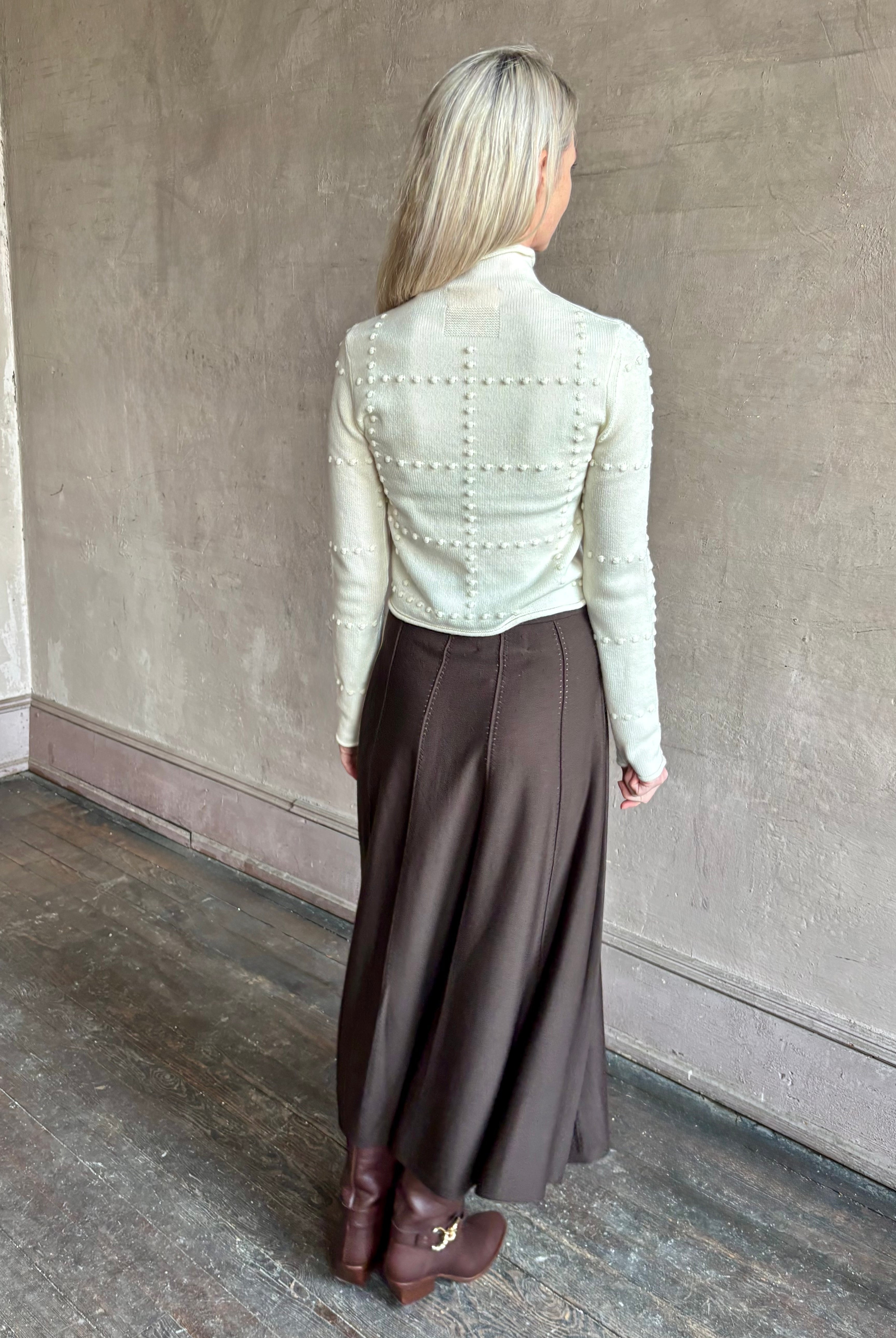 Woman wearing TWP Willow Knit Skirt in chocolate brown premium Merino Wool Knit A-line Skirt