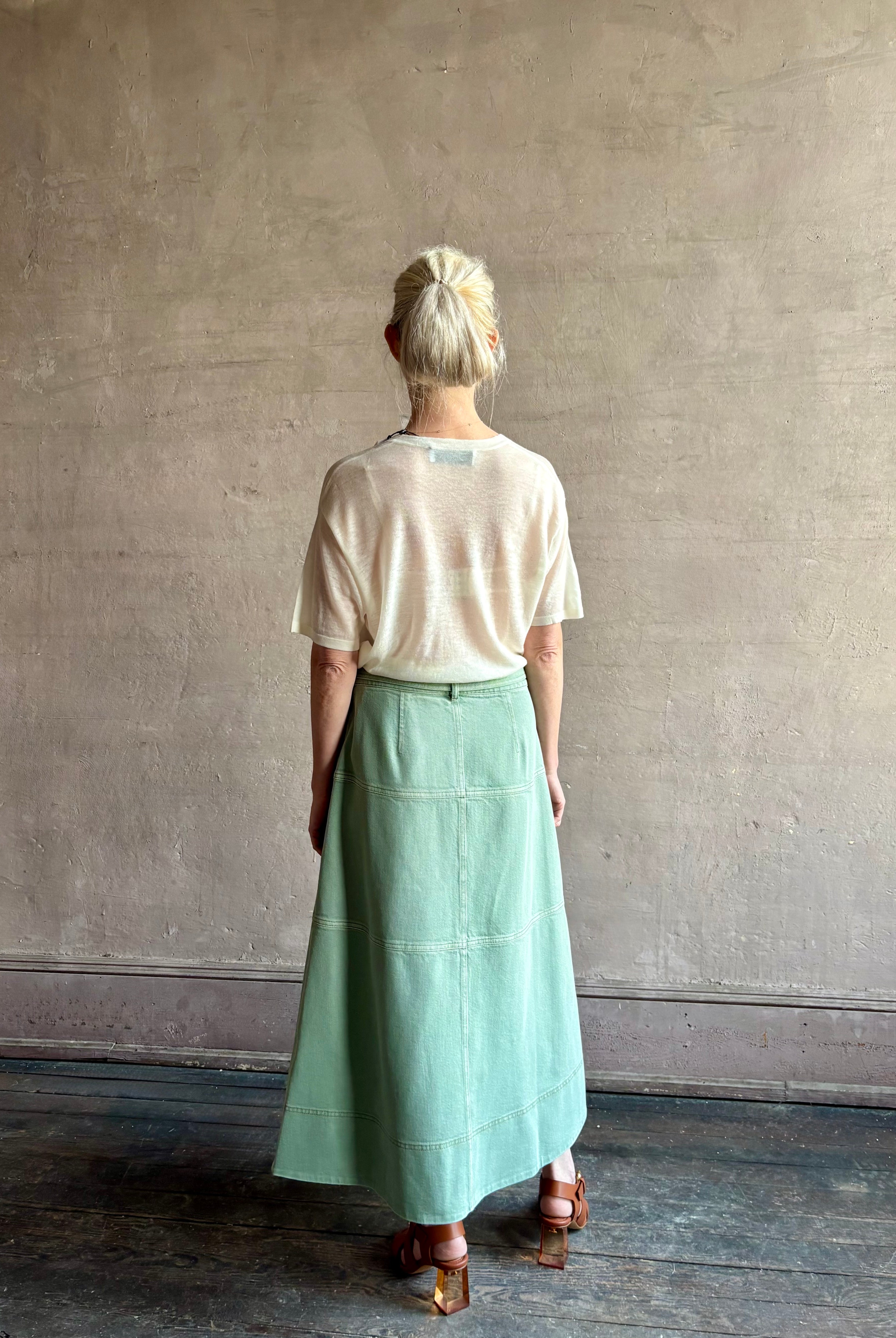 woman wearing premium designer Tanya Taylor Hudley tiered cotton maxi A-line Skirt in Pistachio green