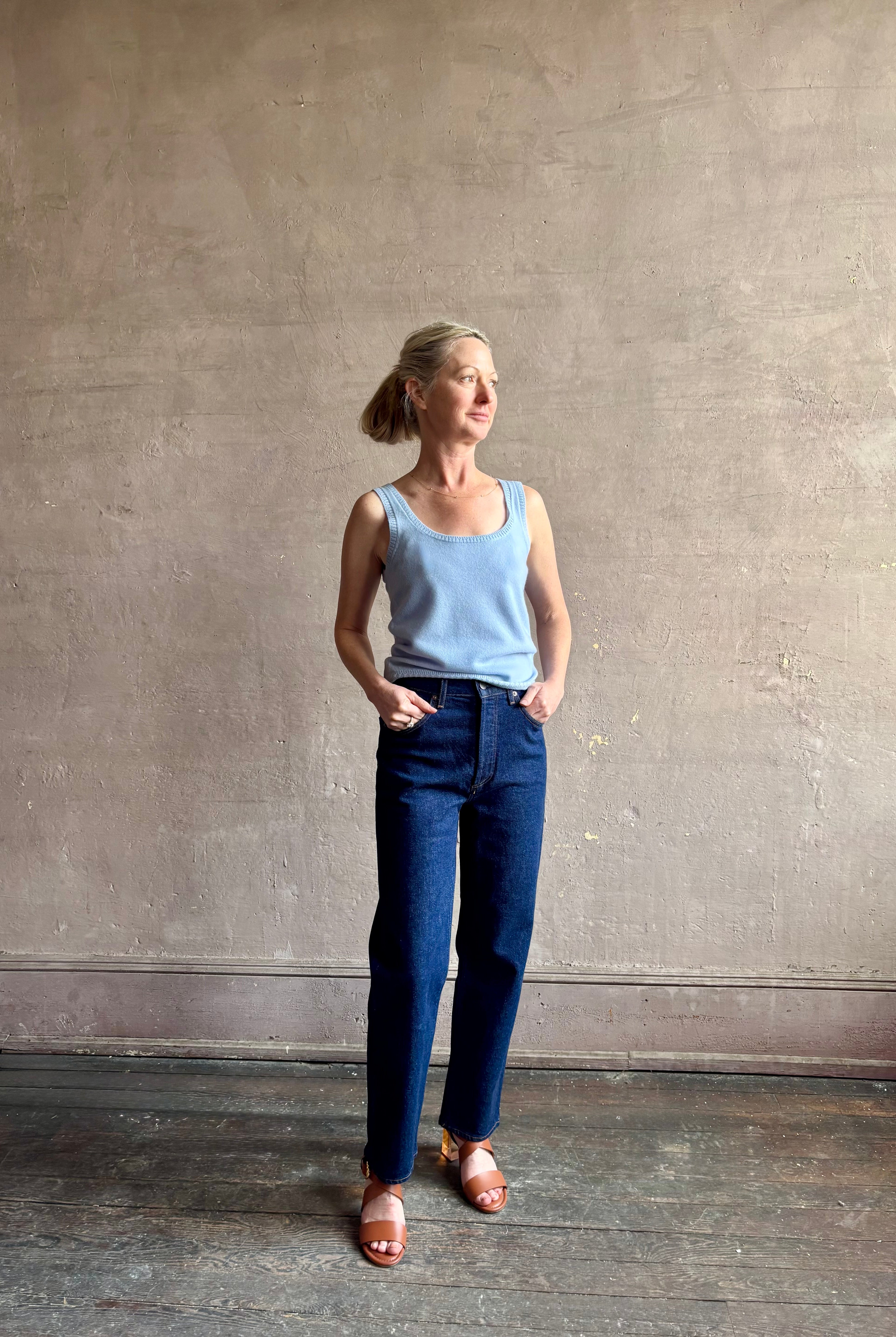 Image of woman wearing luxury cashmere knitwear Tanya Taylor Rory Cashmere Tank top in Pale Blue with a feminine scoop neckline