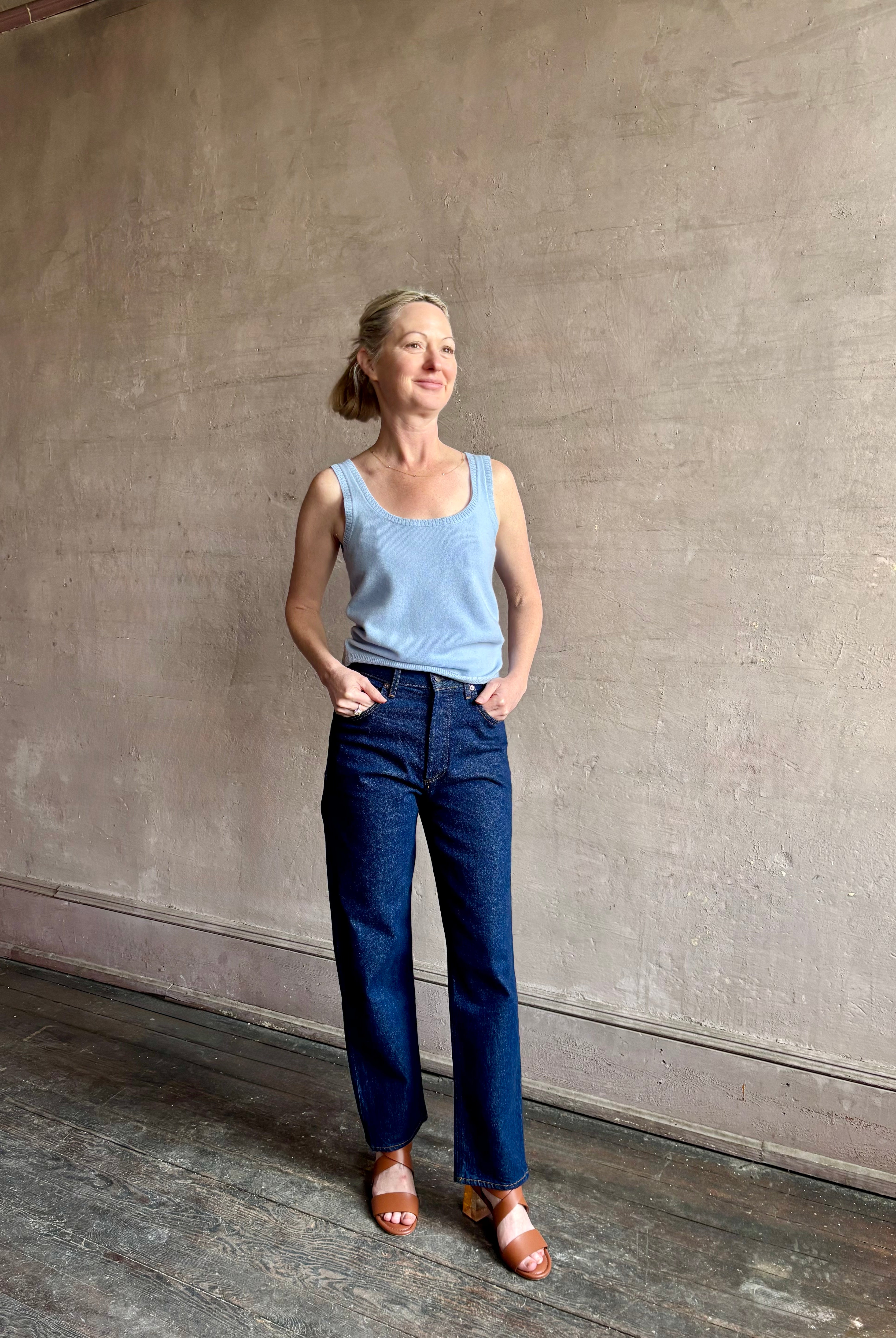 Image of woman wearing luxury cashmere knitwear Tanya Taylor Rory Cashmere Tank top in Pale Blue with a feminine scoop neckline