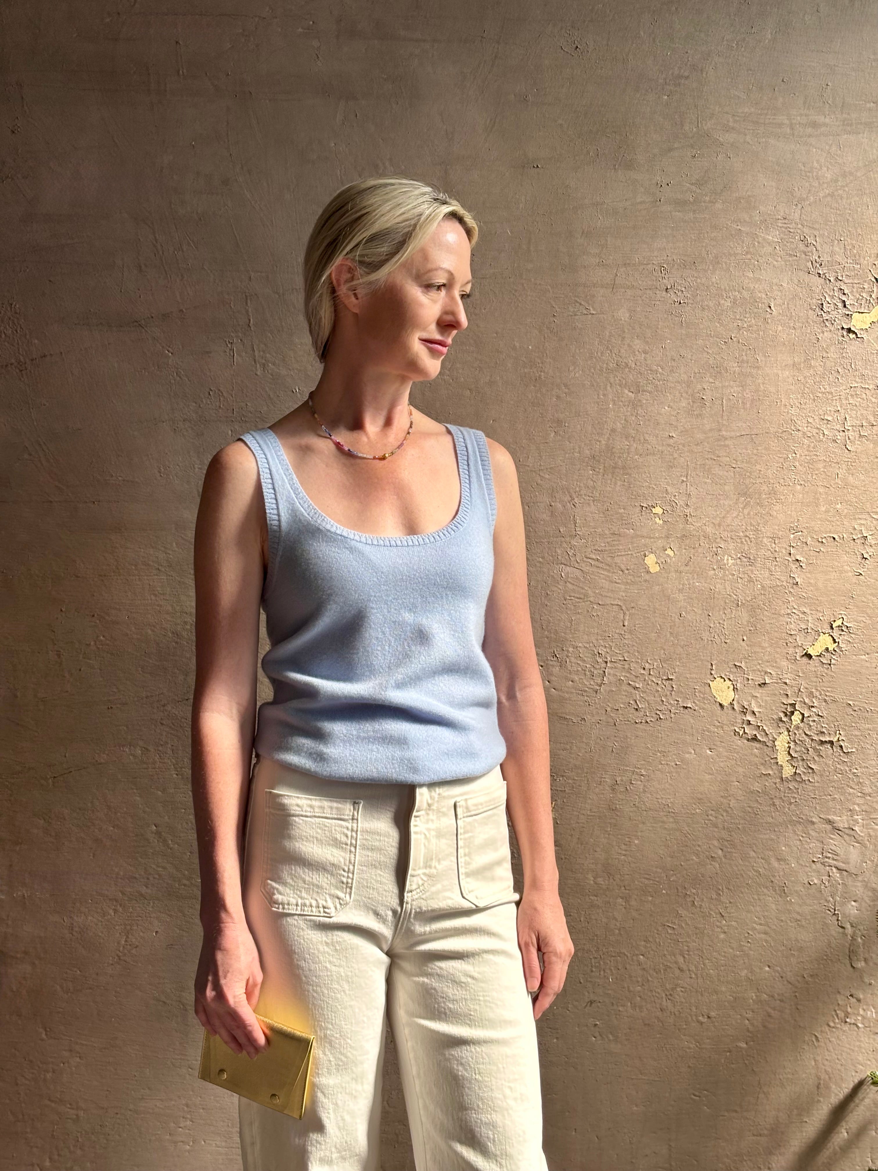 Image of woman wearing luxury cashmere knitwear Tanya Taylor Rory Cashmere Tank top in Pale Blue with a feminine scoop neckline