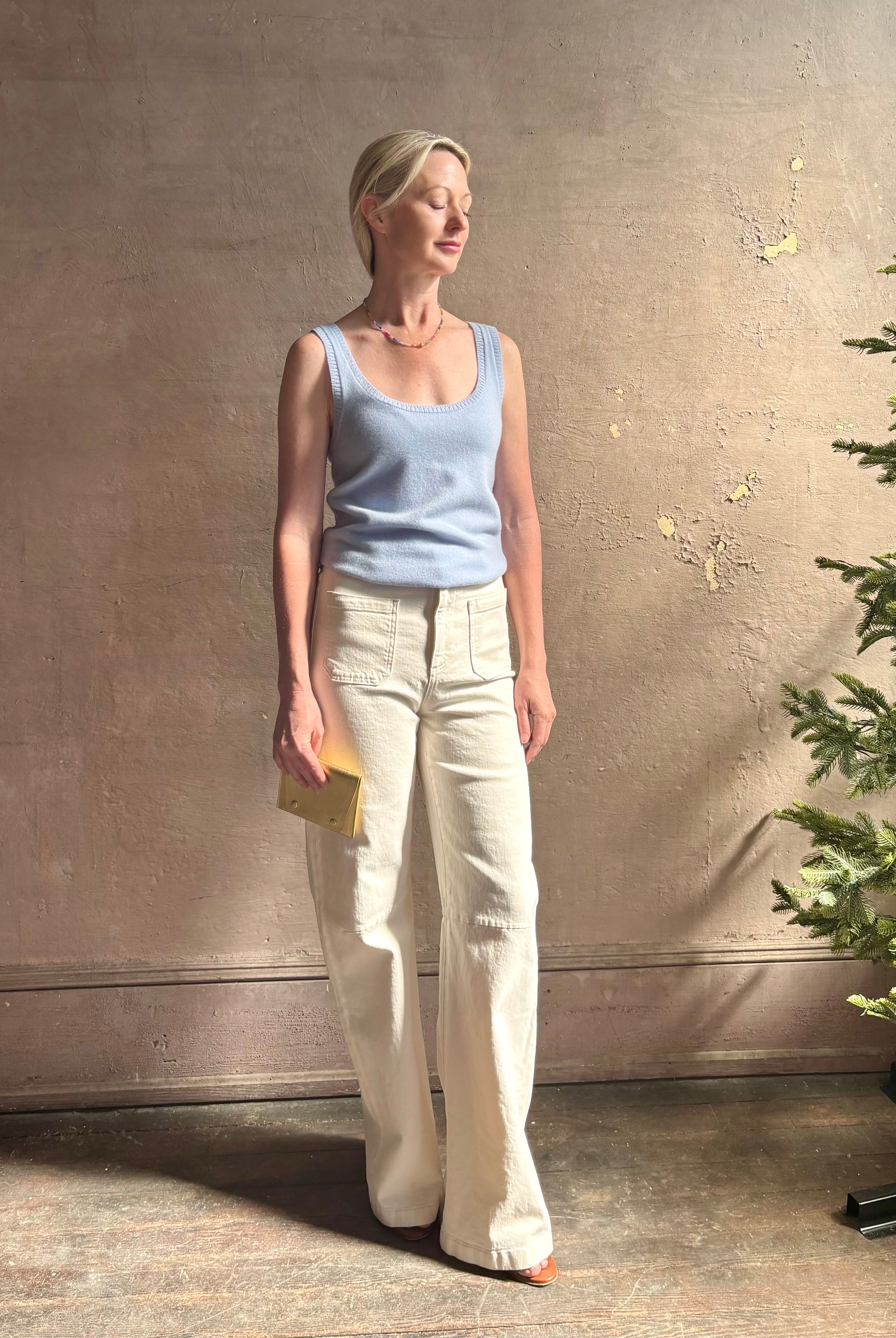 Image of woman wearing luxury cashmere knitwear Tanya Taylor Rory Cashmere Tank top in Pale Blue with a feminine scoop neckline