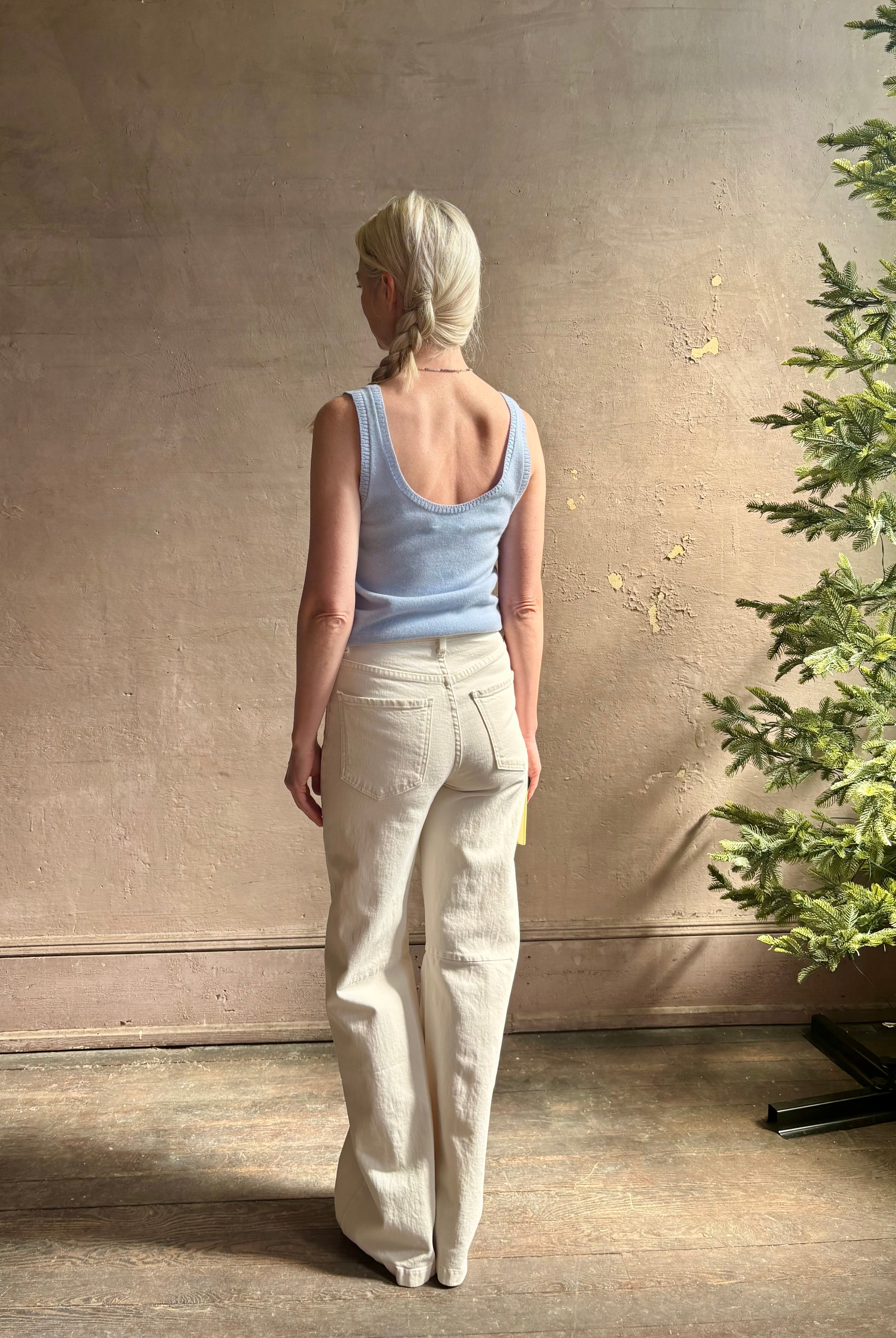 Image of woman wearing luxury cashmere knitwear Tanya Taylor Rory Cashmere Tank top in Pale Blue with a feminine scoop neckline