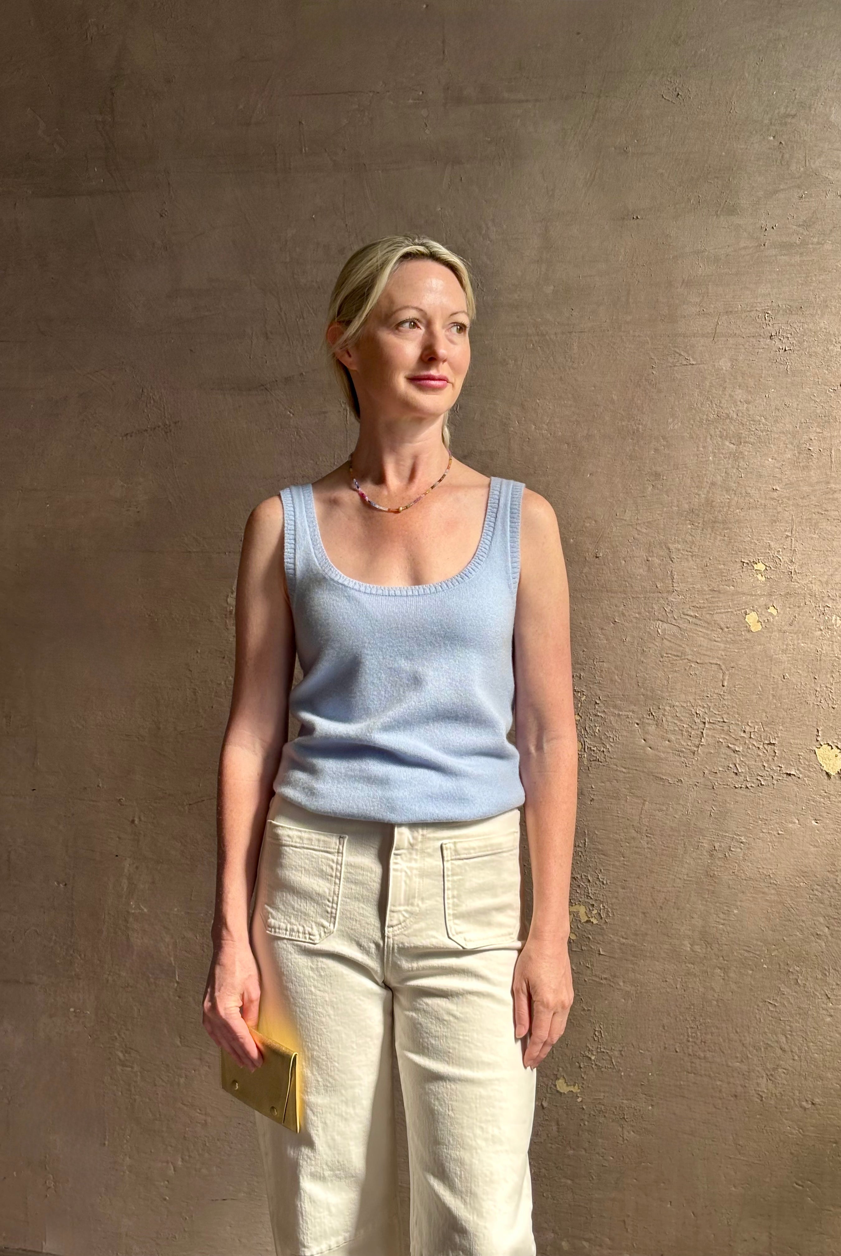 Image of woman wearing luxury cashmere knitwear Tanya Taylor Rory Cashmere Tank top in Pale Blue with a feminine scoop neckline