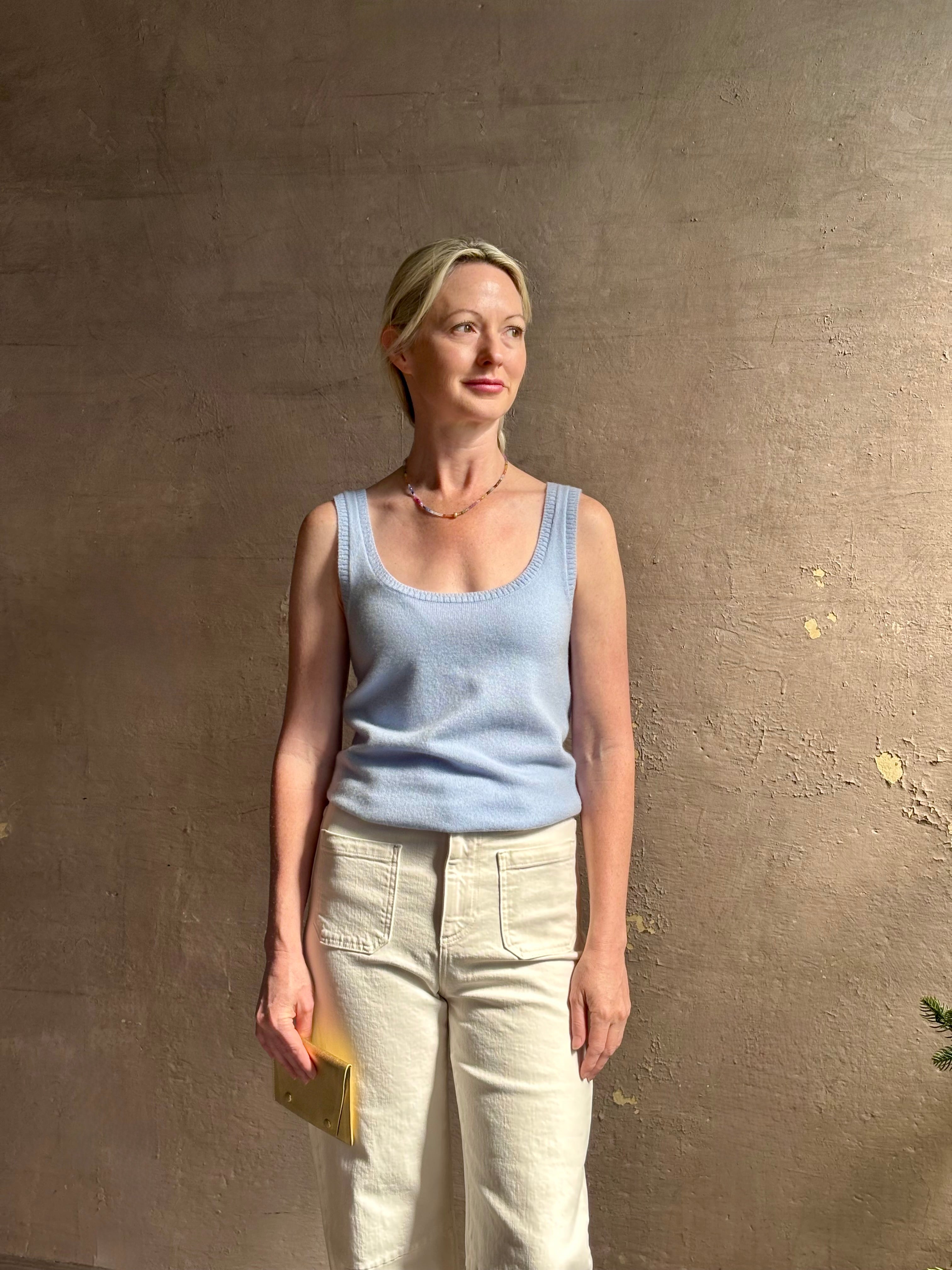 Image of woman wearing luxury cashmere knitwear Tanya Taylor Rory Cashmere Tank top in Pale Blue with a feminine scoop neckline