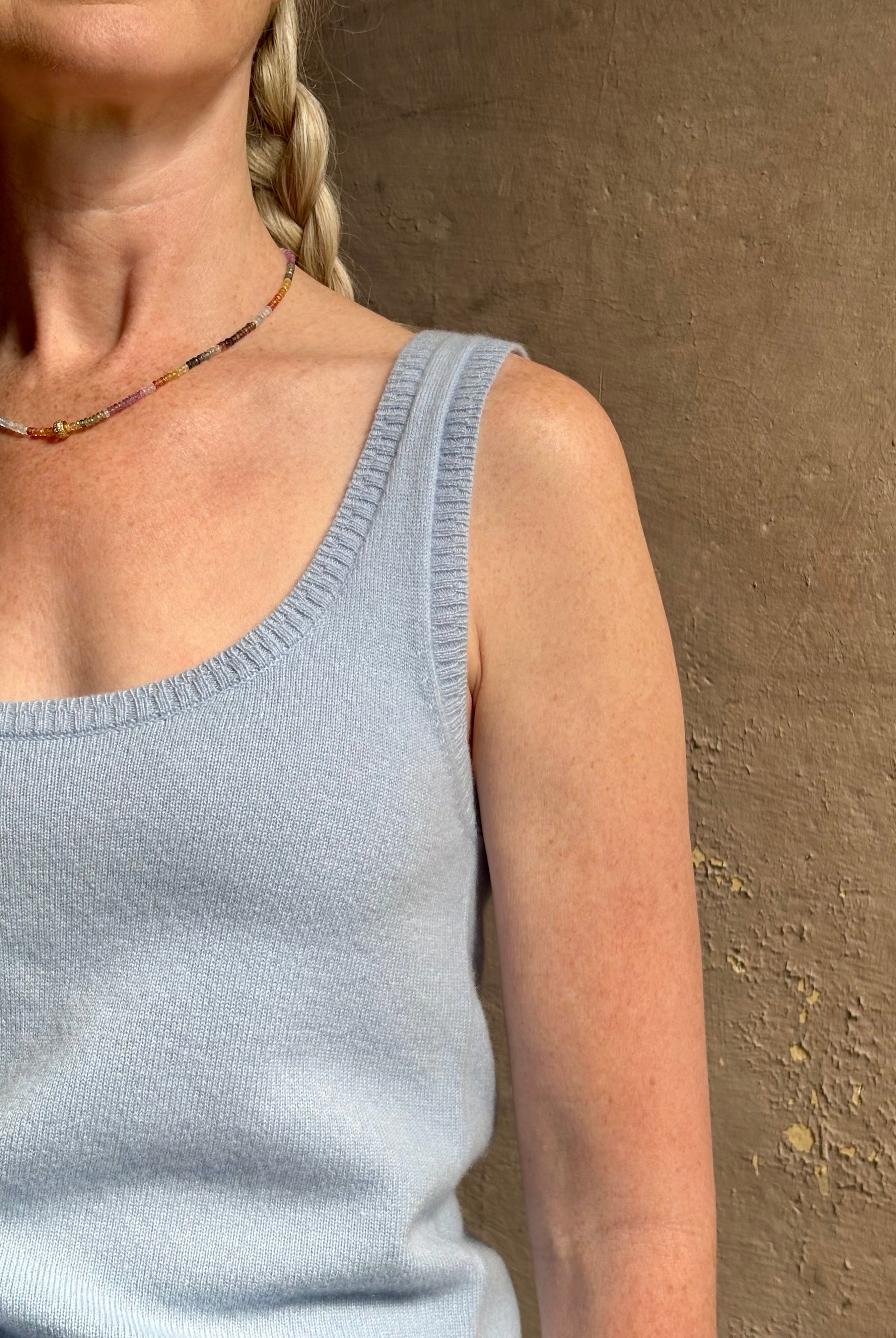 Image of woman wearing luxury cashmere knitwear Tanya Taylor Rory Cashmere Tank top in Pale Blue with a feminine scoop neckline