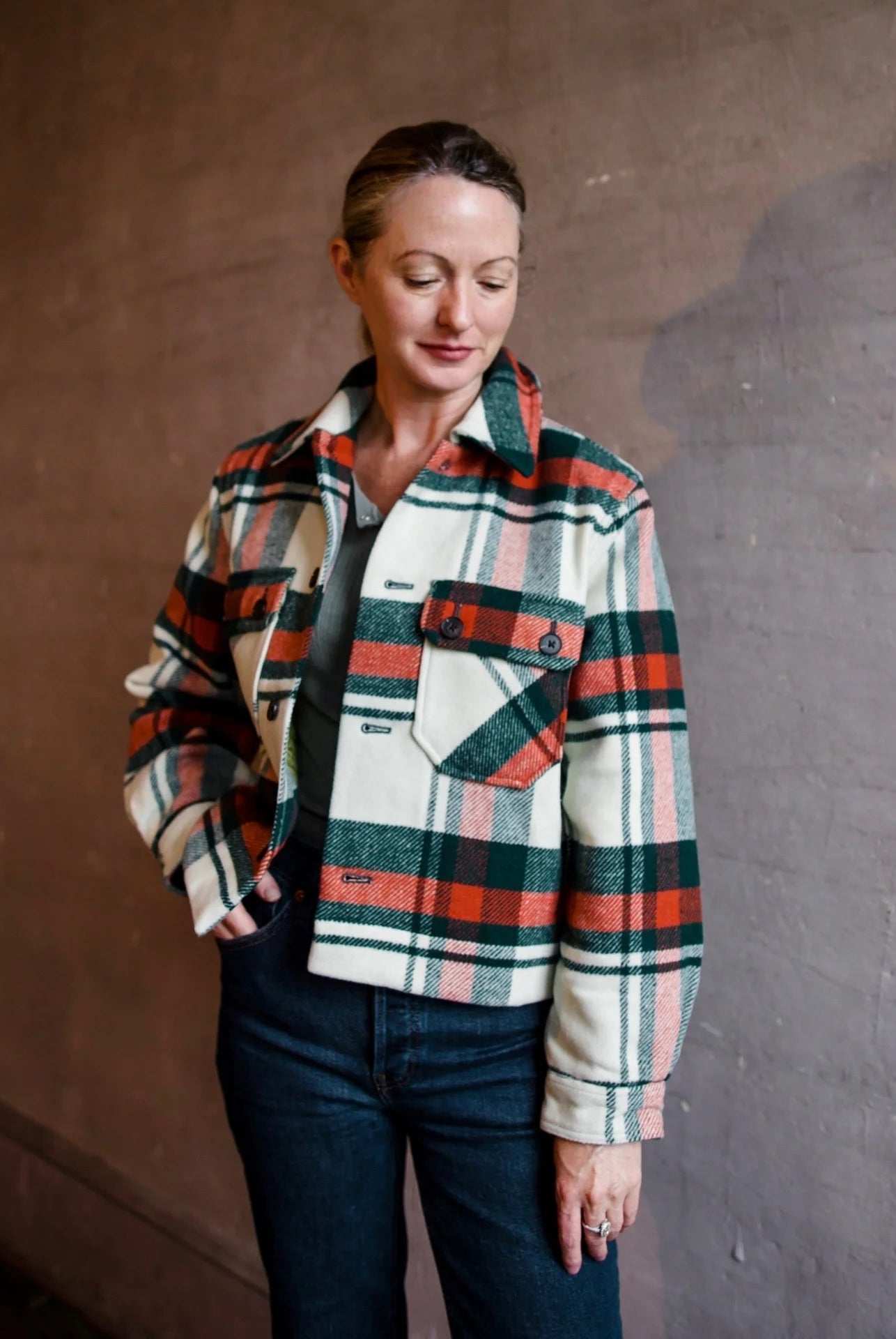 Image featuring a woman wearing The Great Smith fully lined jacket from The Great with a boxy fit through the body, a slightly cropped length and subtle swing at the back.
