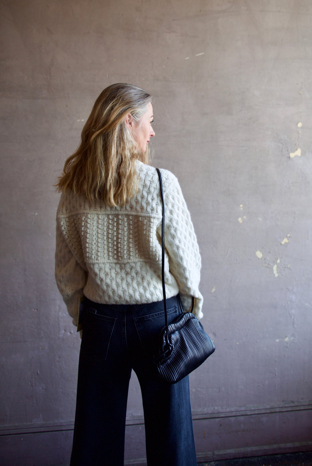 Mature woman wearing the Lara sweater by Trovata with a crew neckline and blocked woven texture in cream.