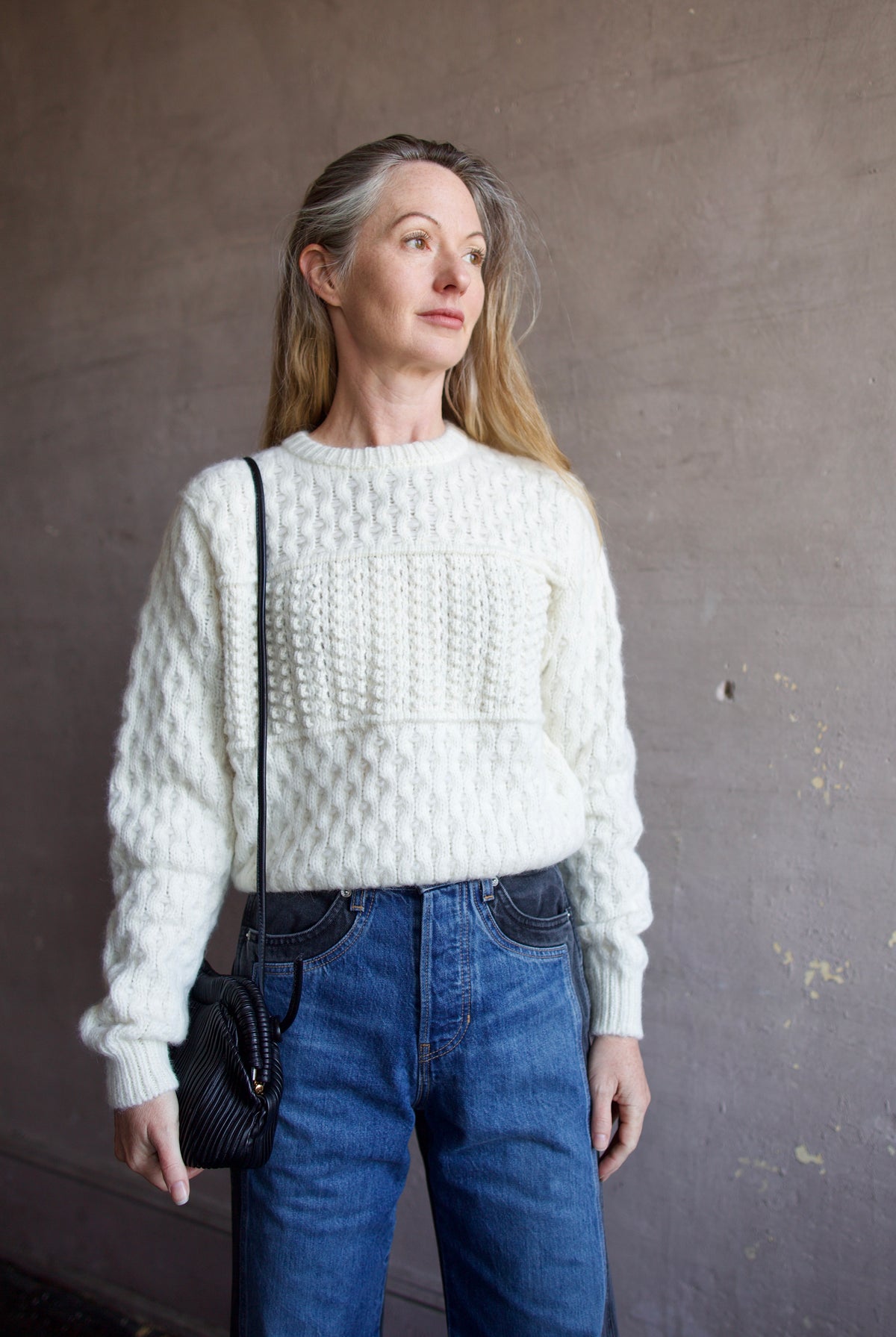 Mature woman wearing the Lara sweater by Trovata with a crew neckline and blocked woven texture in cream.
