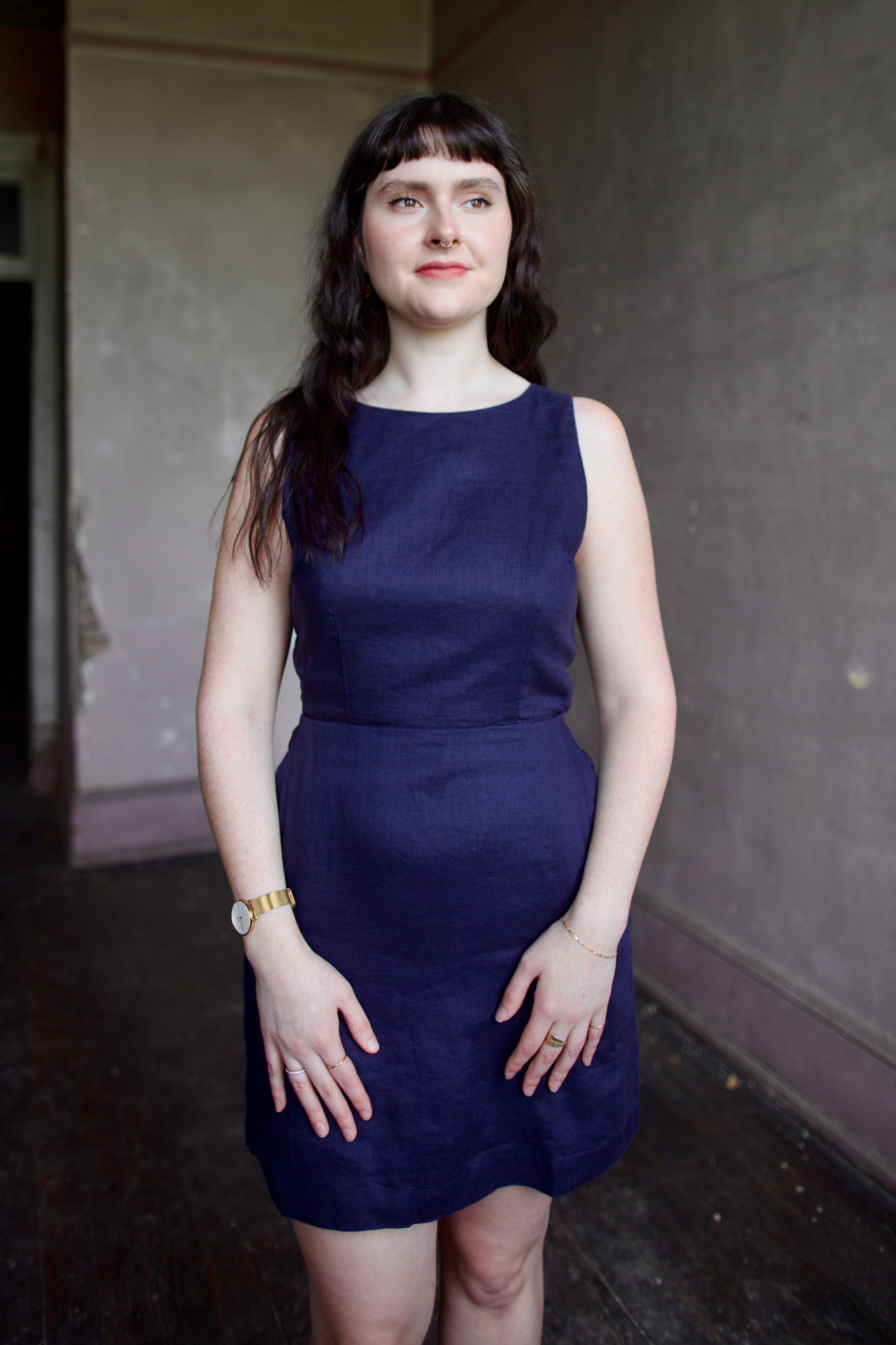 Model wearing the Trovata Rosalie linen Dress in Navy Blue with A-line skirt and sophisticated bra friendly open back