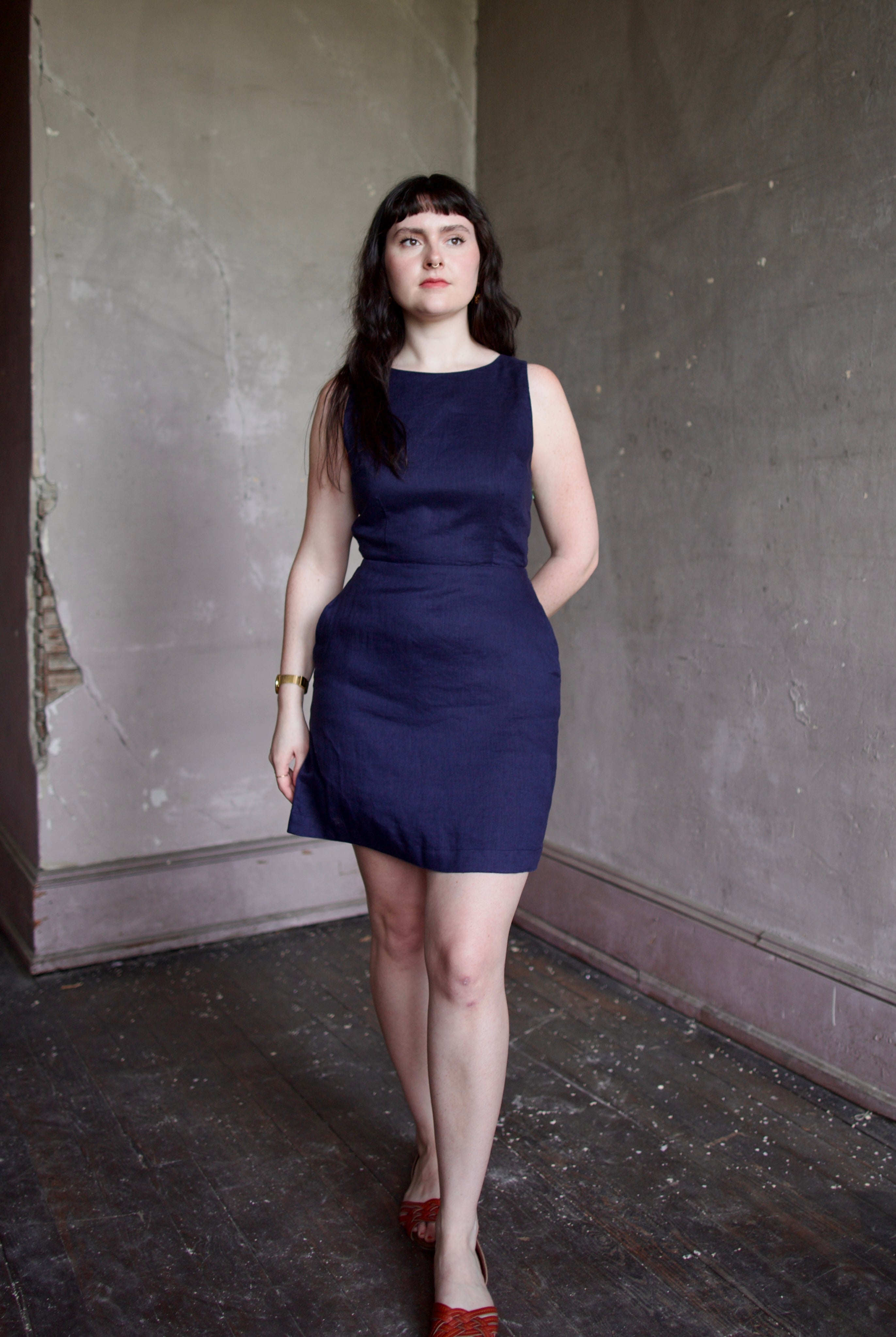 Model wearing the Trovata Rosalie linen Dress in Navy Blue with A-line skirt and sophisticated bra friendly open back