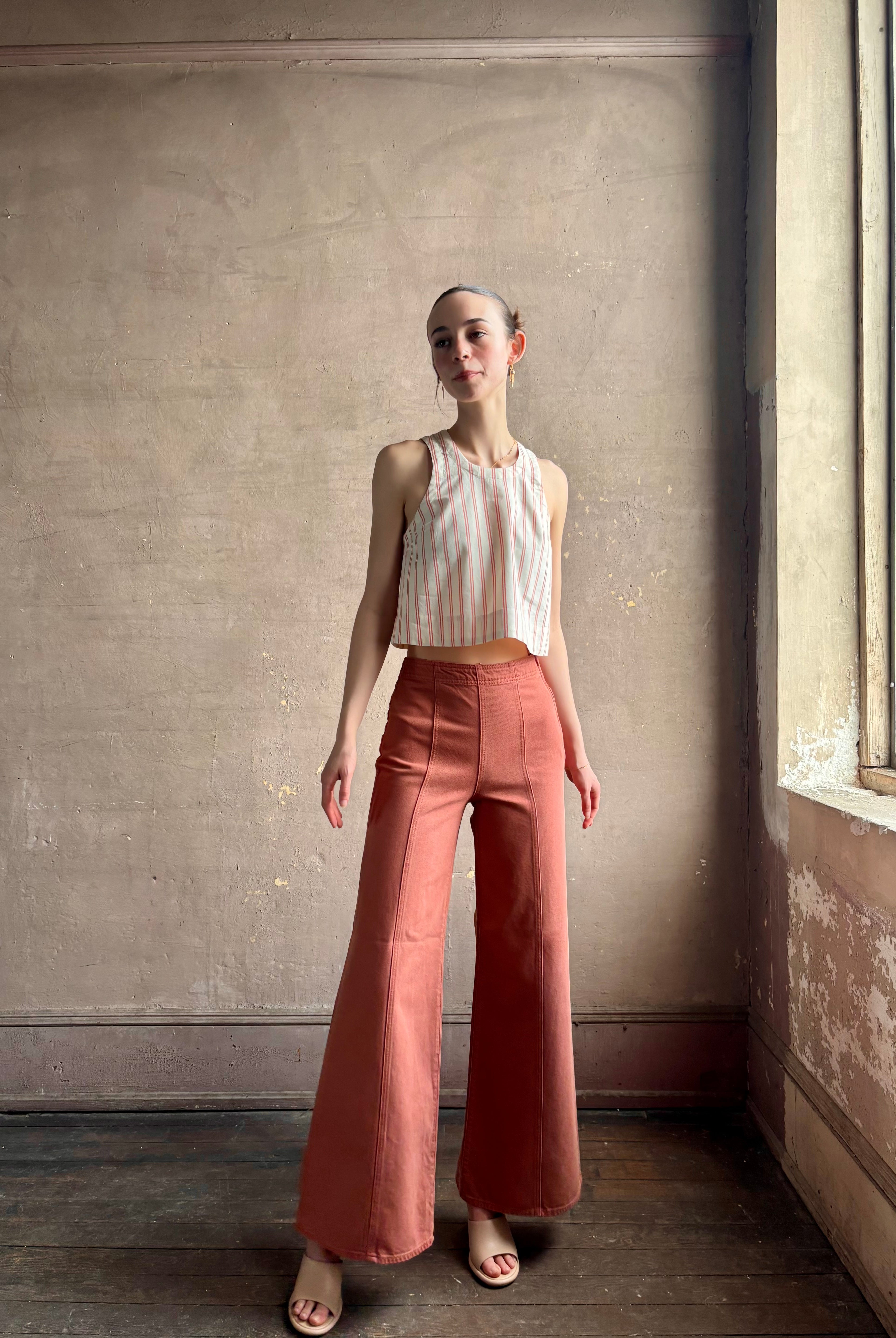 Woman wearing premium elevated casual wear Trovata Esther crew neck sleeveless cotton poplin crop top in cream and rose stripe