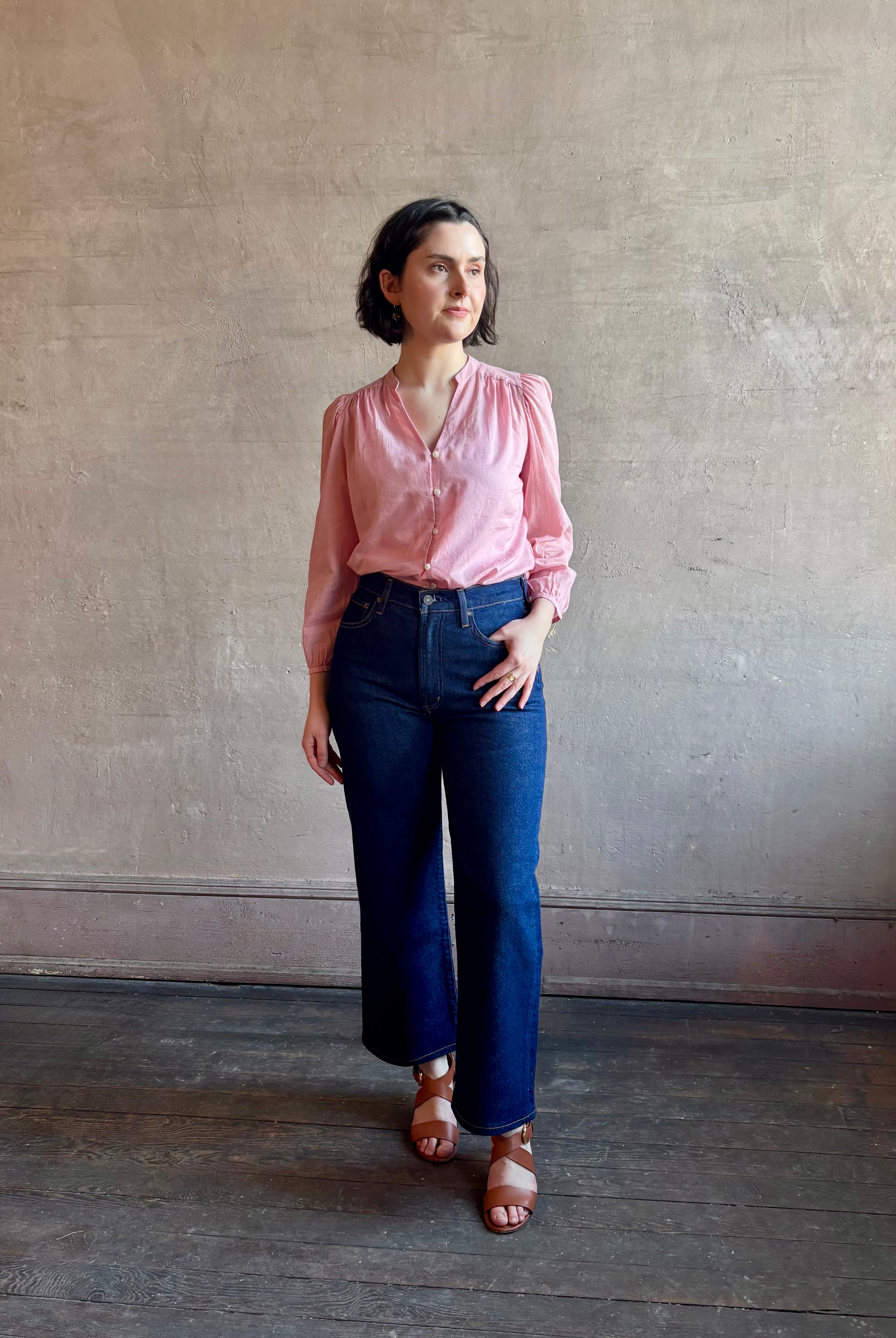 Woman wearing premium lightweight cotton poplin Maisey Blouse by Trovata with long sleeves and v-neck in pink and white tiny Houndstooth print
