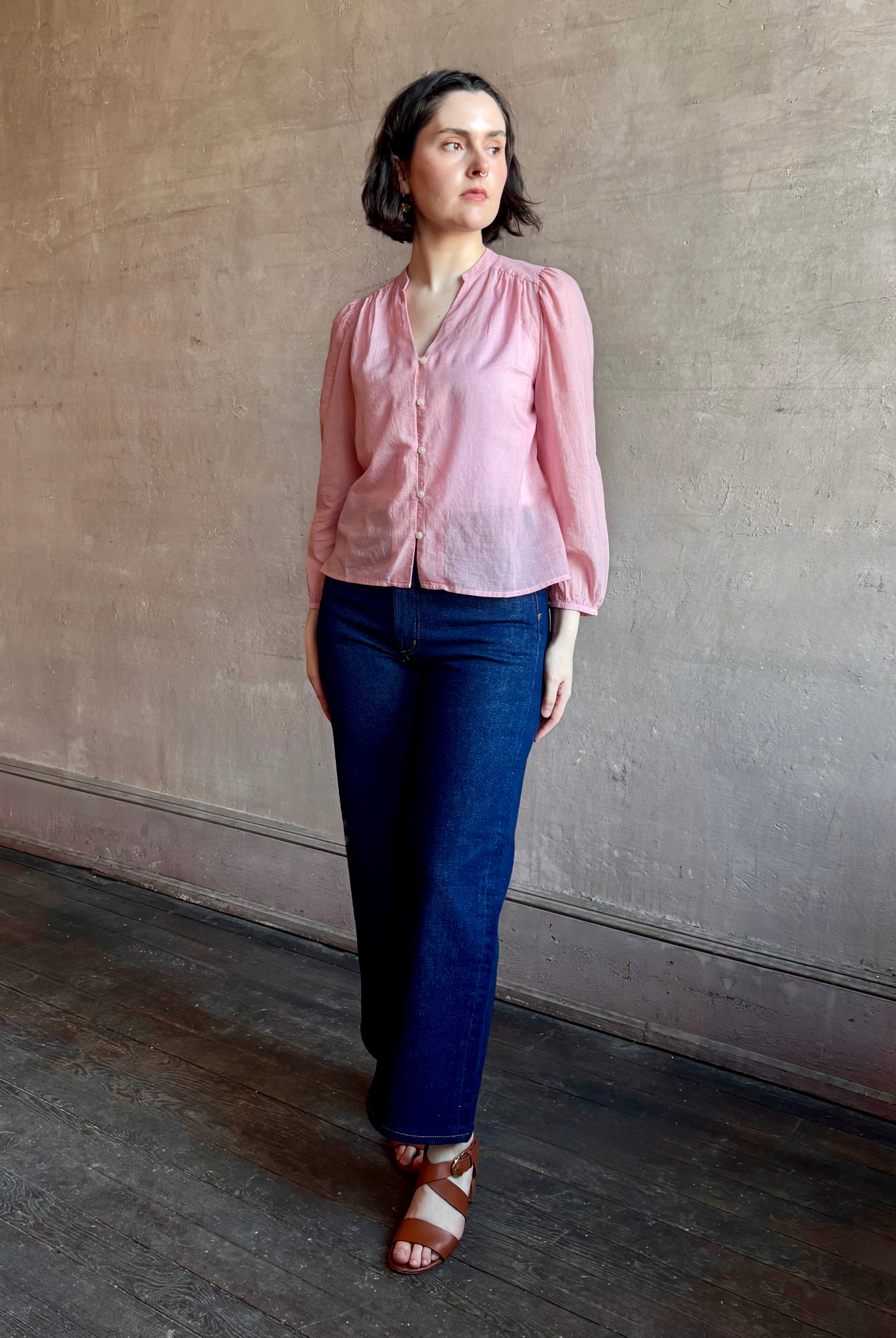 Woman wearing premium lightweight cotton poplin Maisey Blouse by Trovata with long sleeves and v-neck in pink and white tiny Houndstooth print