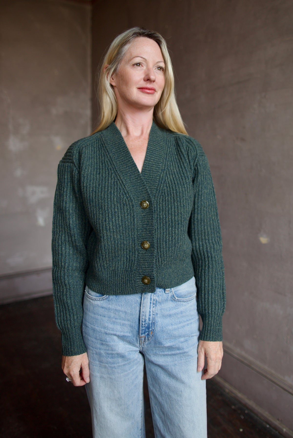 Mature woman wearing TWP Cropped Cardigan in Duffle Bag ribbed cashmere substantial everyday luxury layering