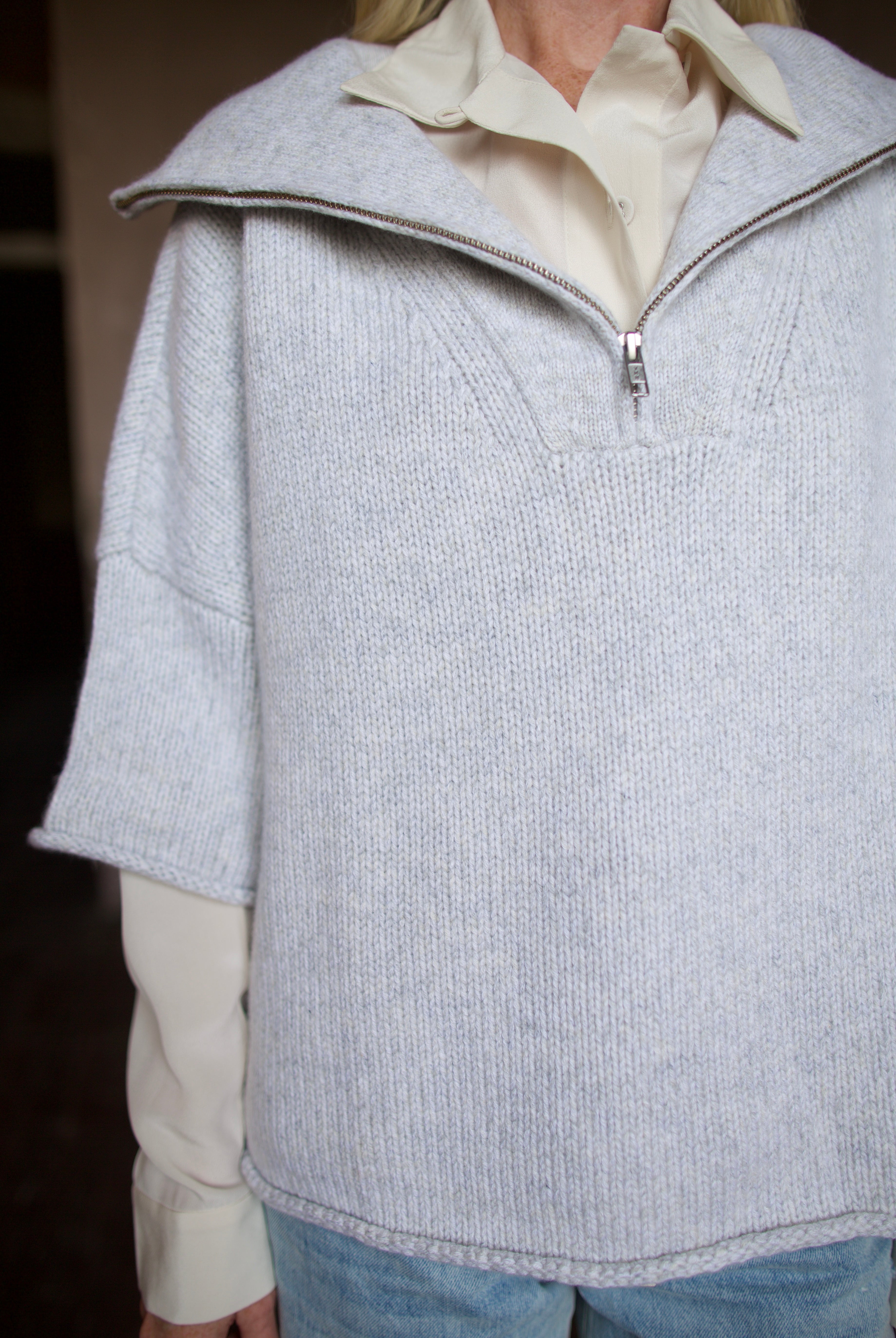 Mature model wearing a light gray layering cashmere sweater with 3/4 zip by American designer TWP