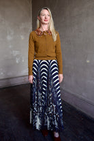 Mature model wearing a brown cashmere cardigan with a sequin embellished collar by Ulla Johnson