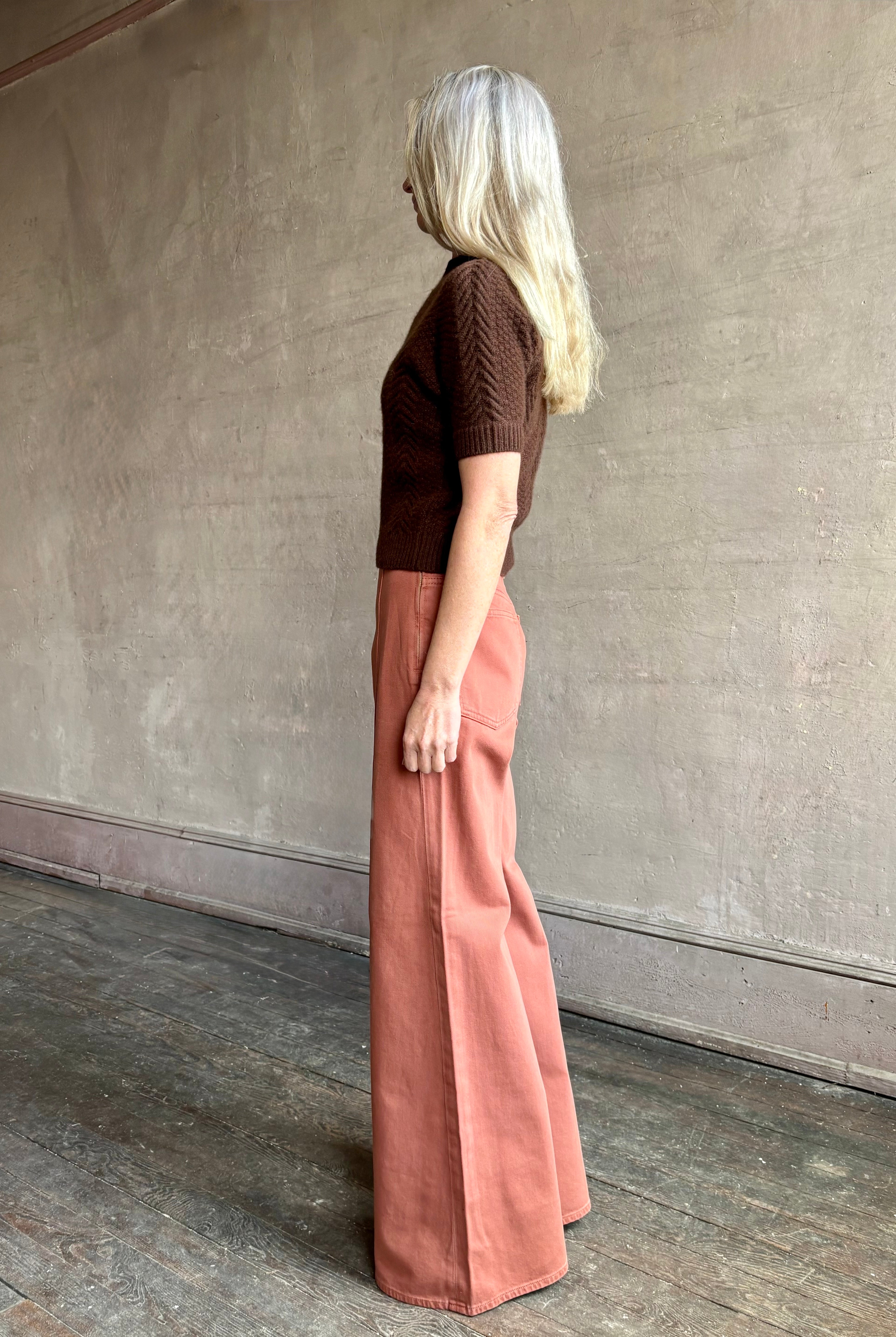 Woman wearing ULLA JOHNSON Bianca faded red rigid Jean with hidden side zip 12" rise and finished hem