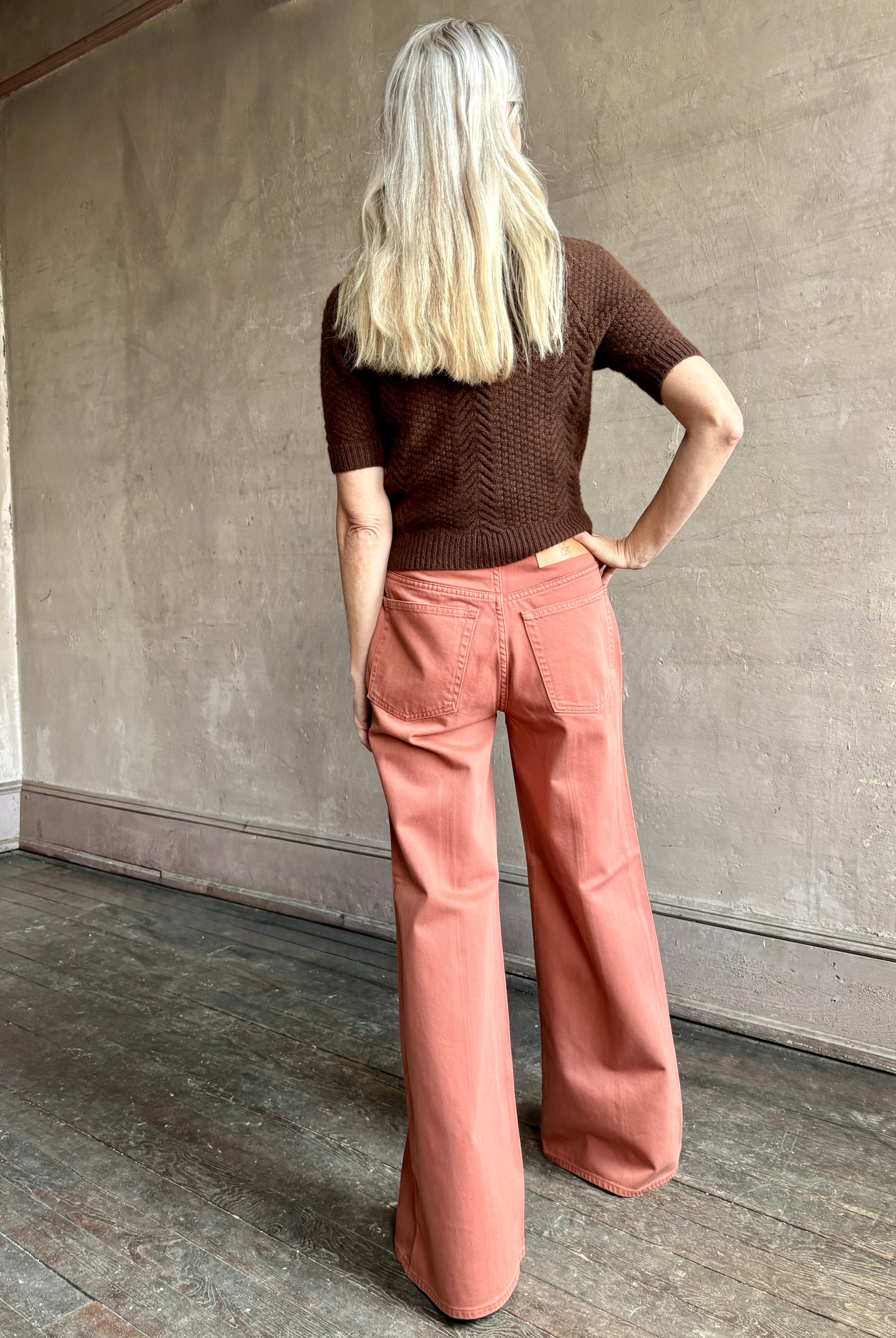 Woman wearing ULLA JOHNSON Bianca faded red rigid Jean with back pockets and leather Ulla tag
