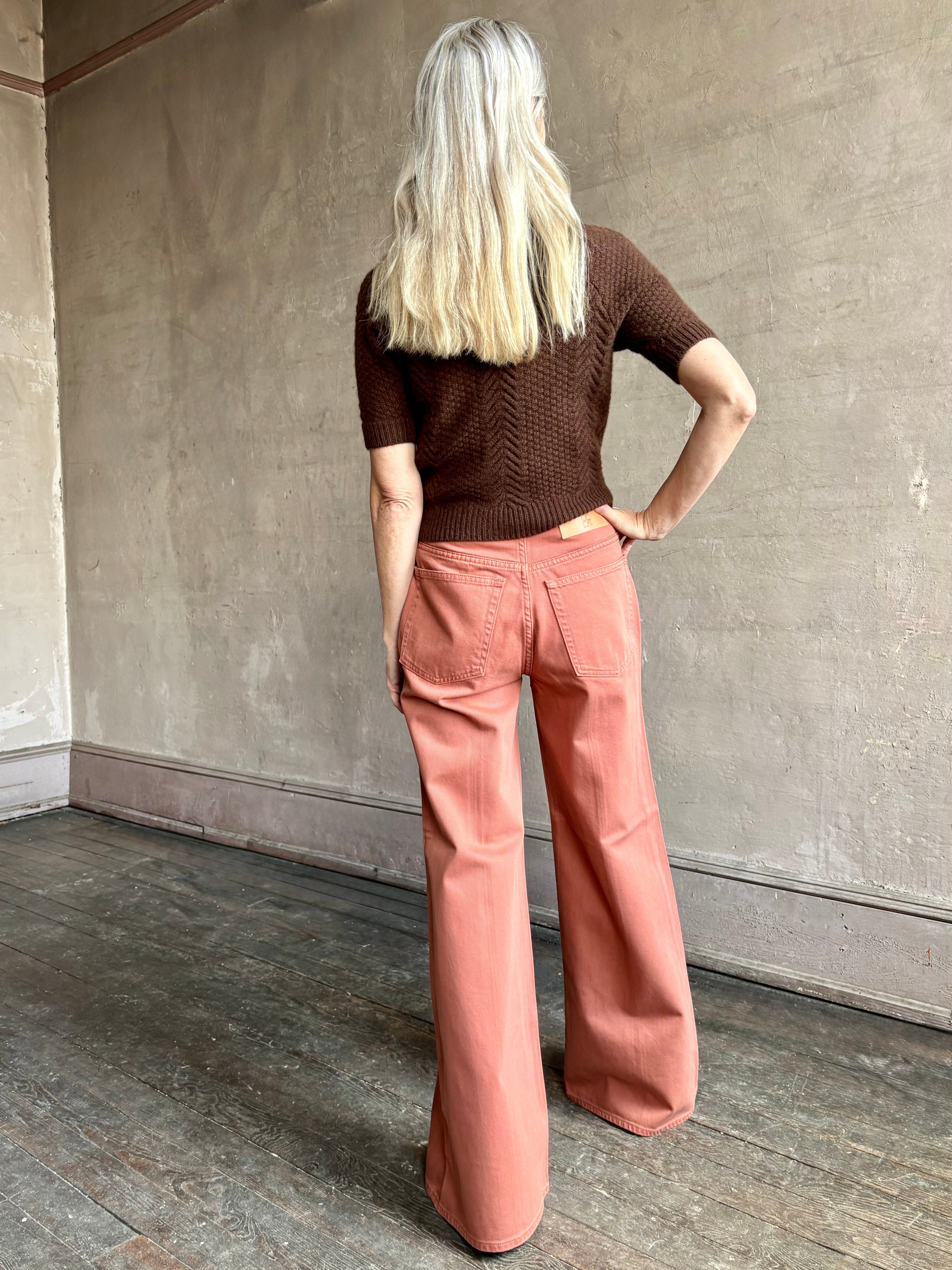 Woman wearing ULLA JOHNSON Bianca faded red rigid Jean with back pockets and leather Ulla tag