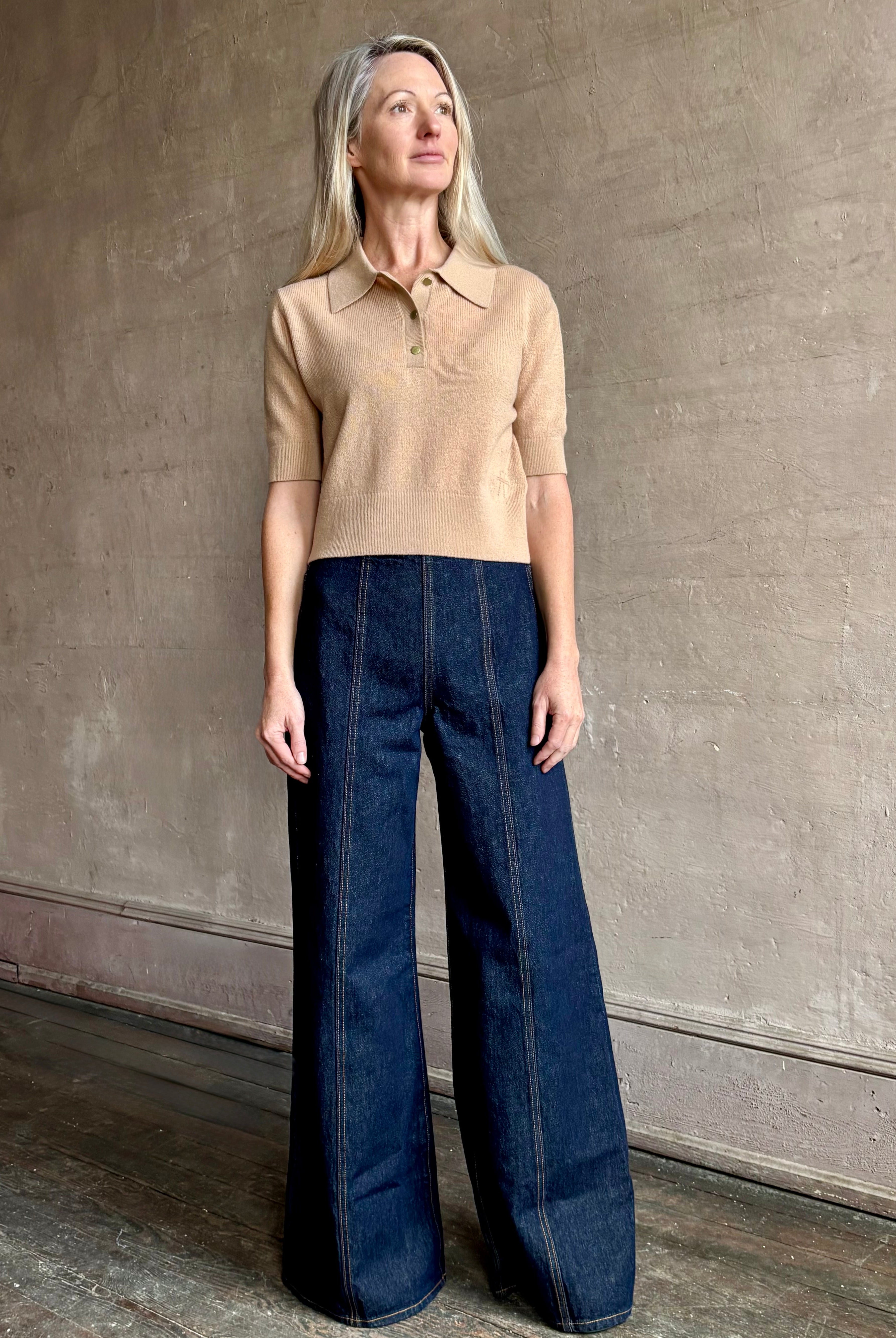 Woman wearing ULLA JOHNSON Bianca dark wash rigid Jean with flat front and front seam details down the middle of each leg