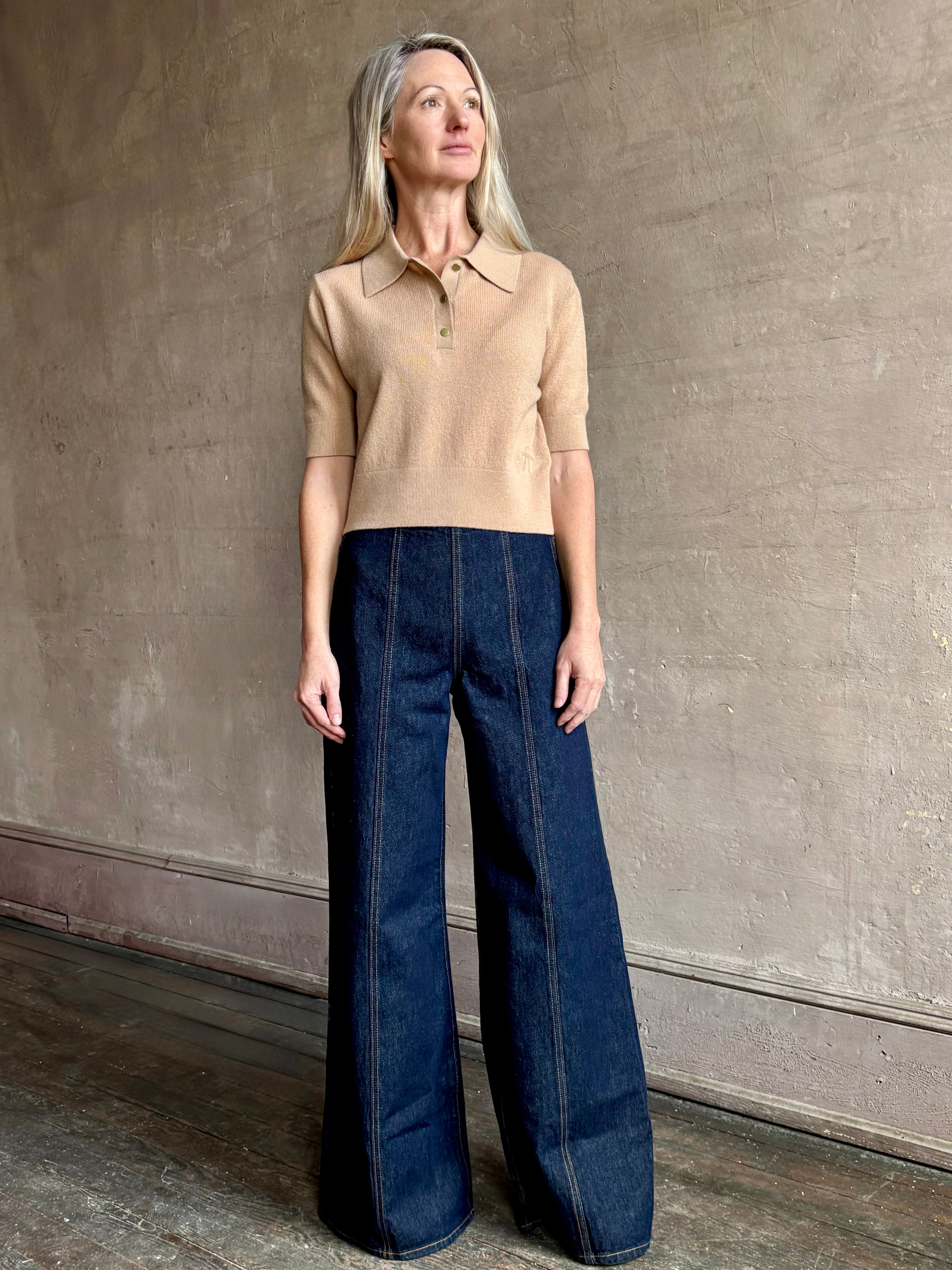 Woman wearing ULLA JOHNSON Bianca dark wash rigid Jean with flat front and front seam details down the middle of each leg