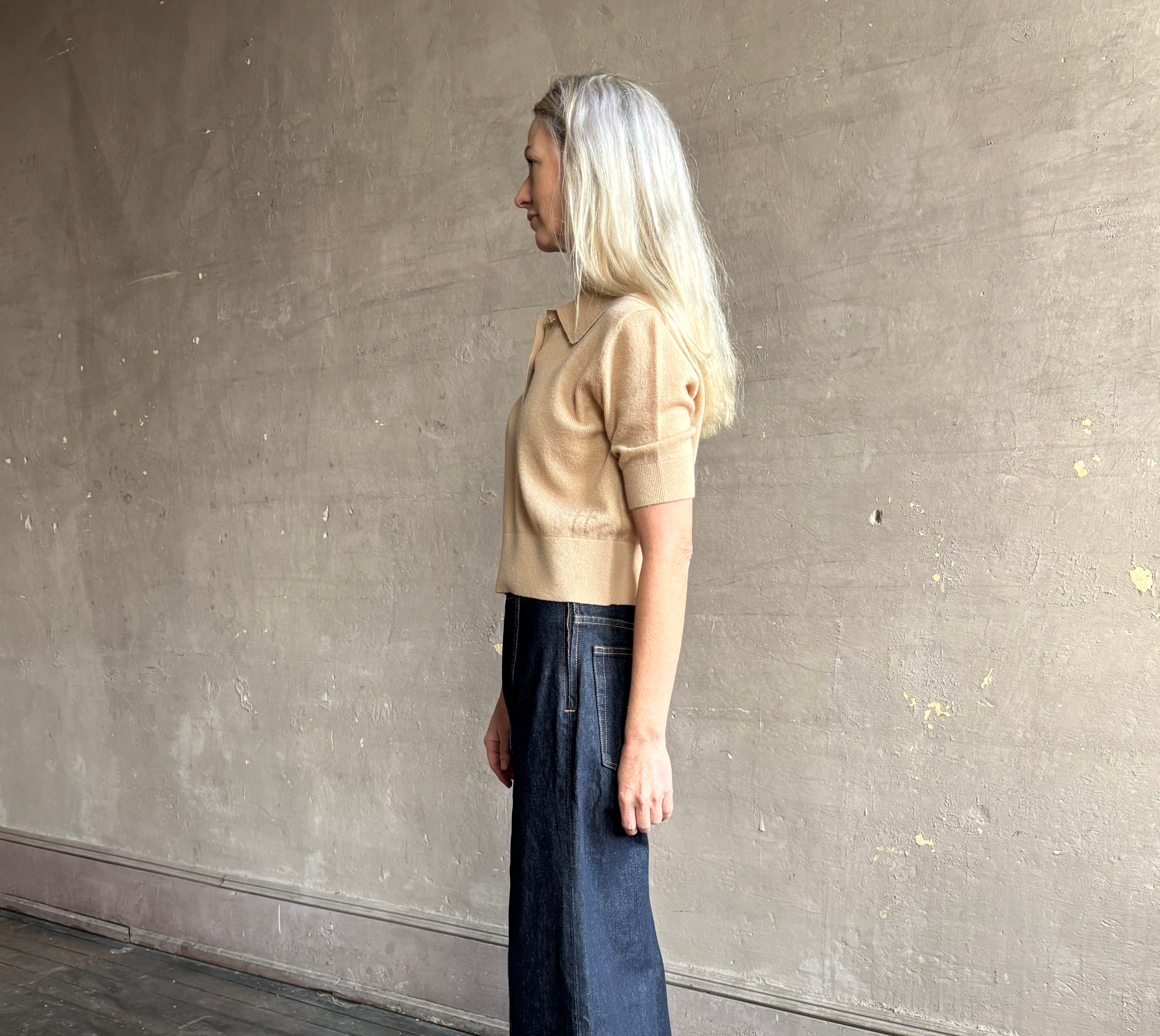 Woman wearing ULLA JOHNSON Bianca dark wash rigid Jean with hidden side zip 12" rise and finished hem