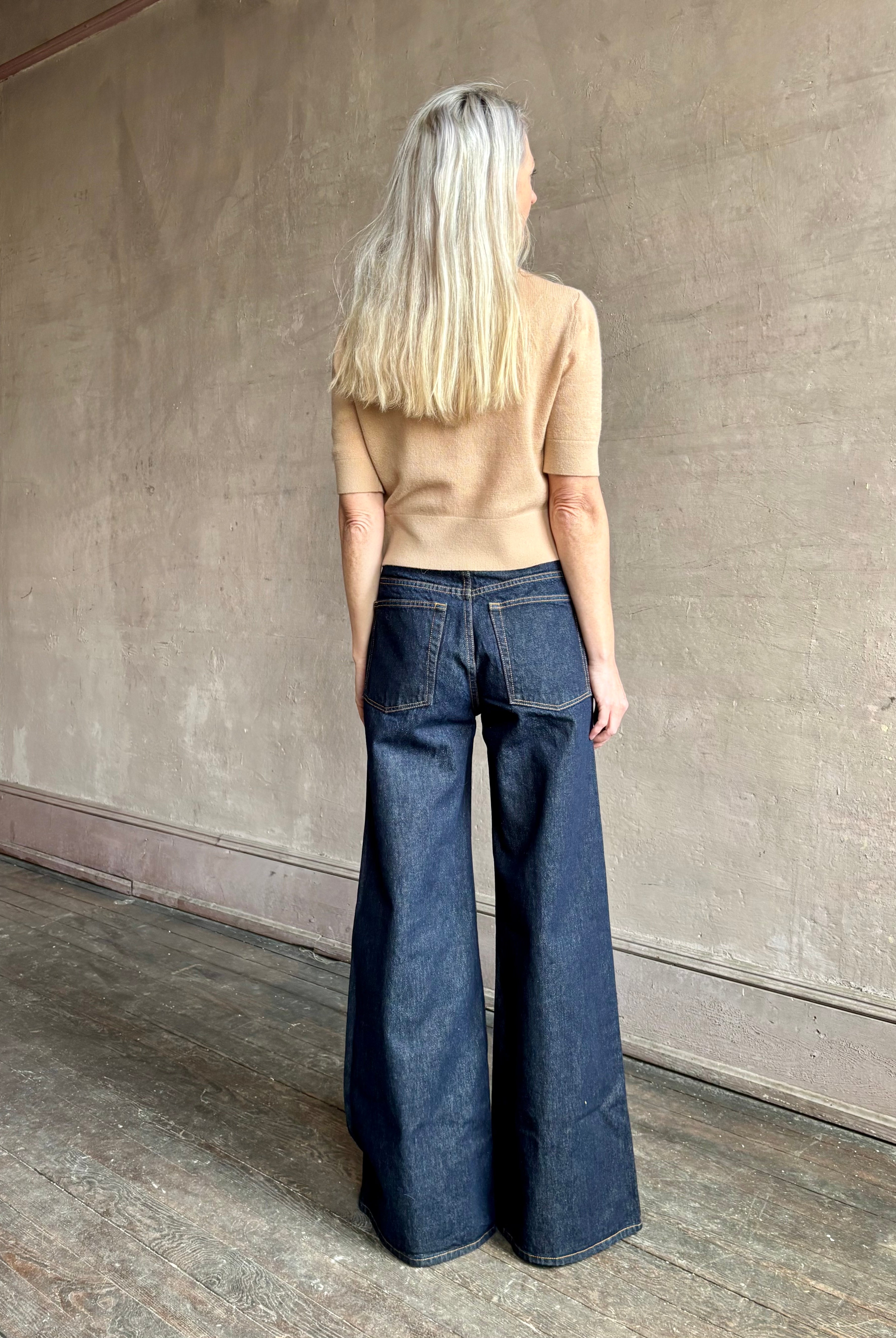 Woman wearing ULLA JOHNSON Bianca dark wash rigid Jean with back pockets and leather Ulla tag