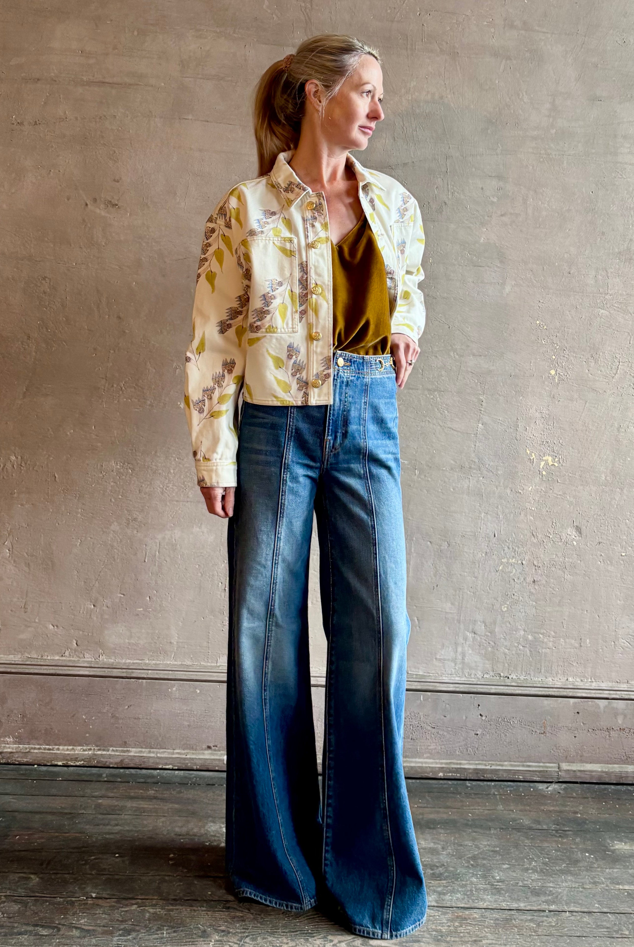 Woman wearing designer ULLA JOHNSON Bobbi denim Jacket in an artisan collaboration print Infinite Flower