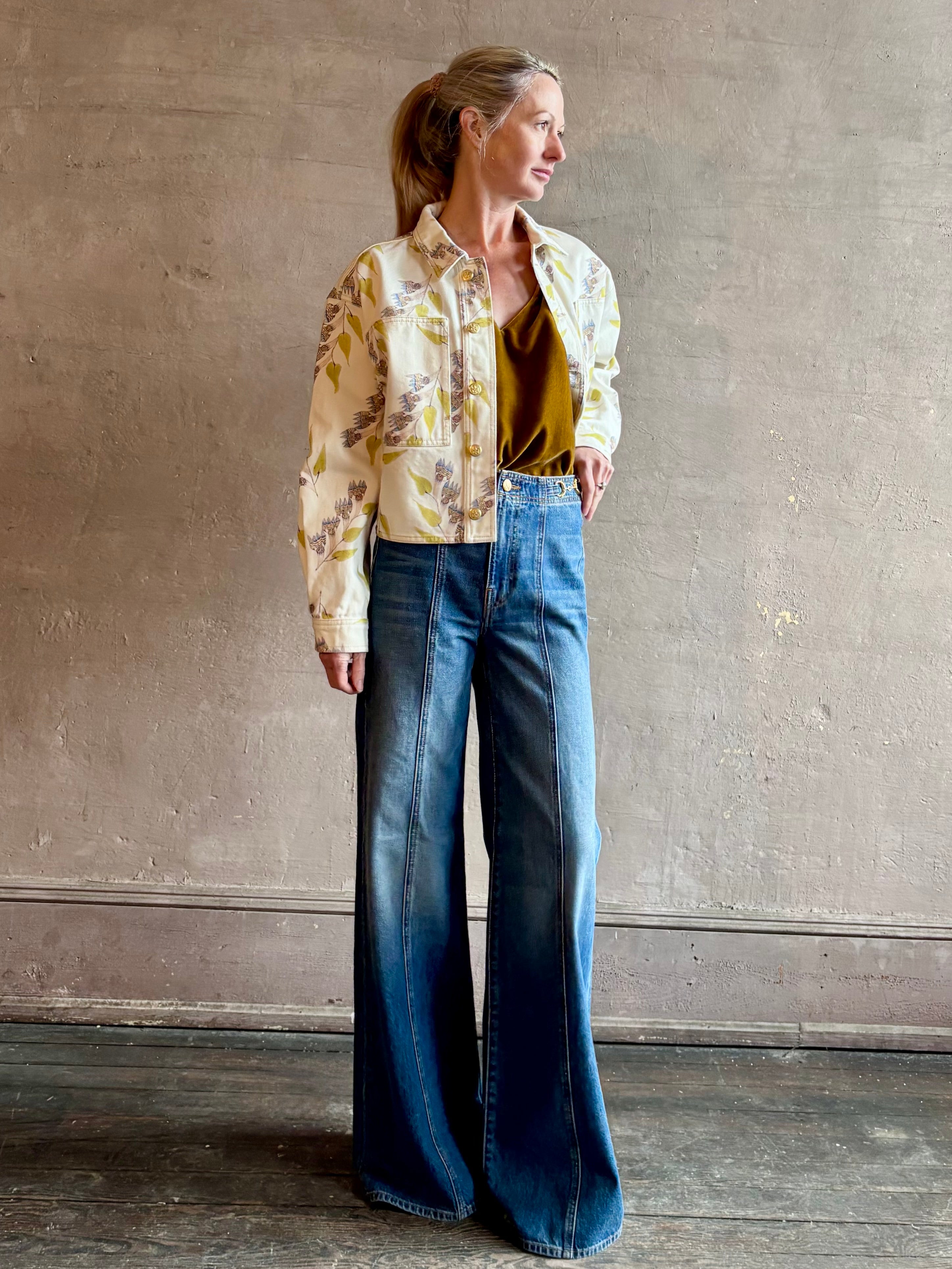 Woman wearing designer ULLA JOHNSON Bobbi denim Jacket in an artisan collaboration print Infinite Flower