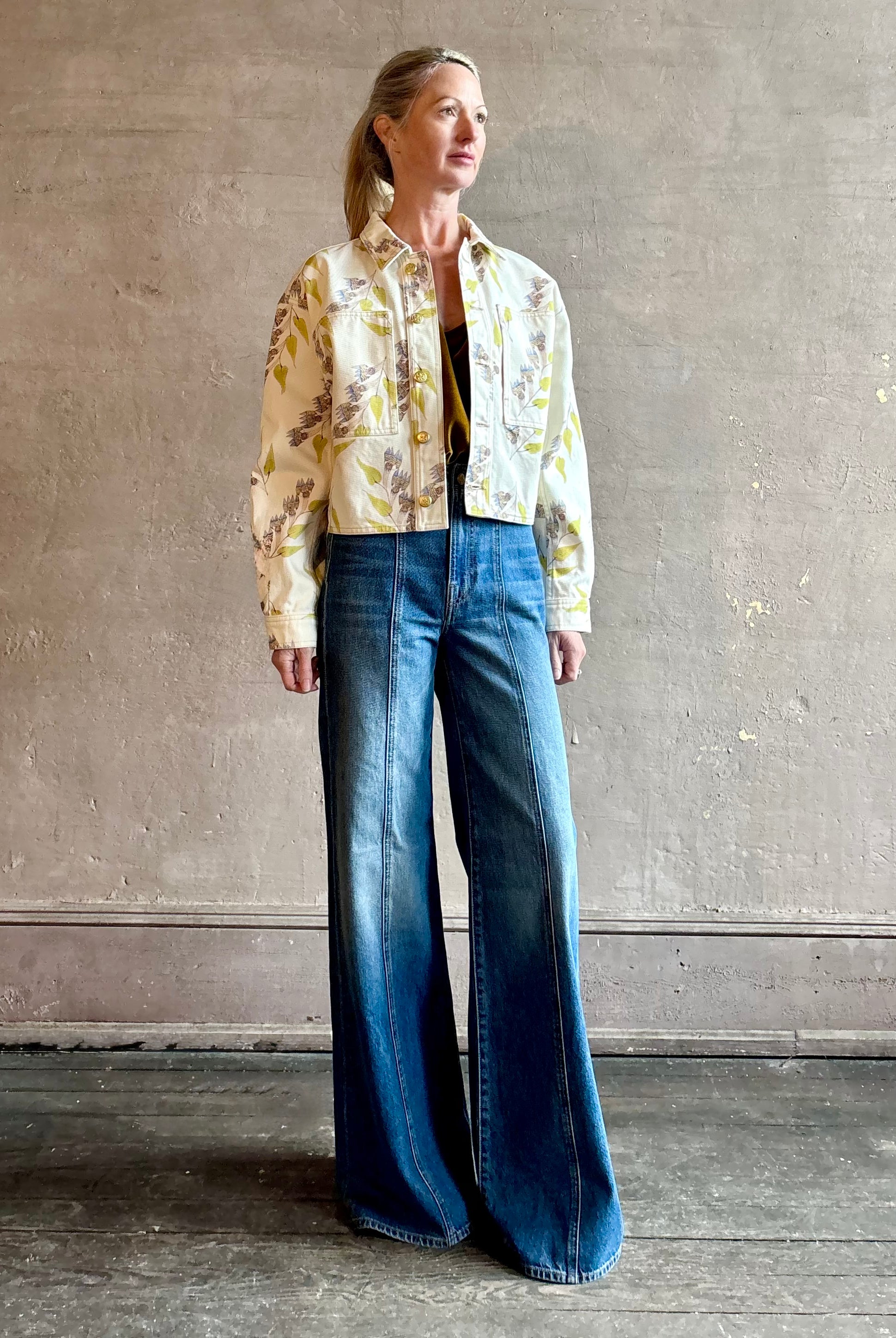 Woman wearing designer ULLA JOHNSON Bobbi denim Jacket in an artisan collaboration print Infinite Flower