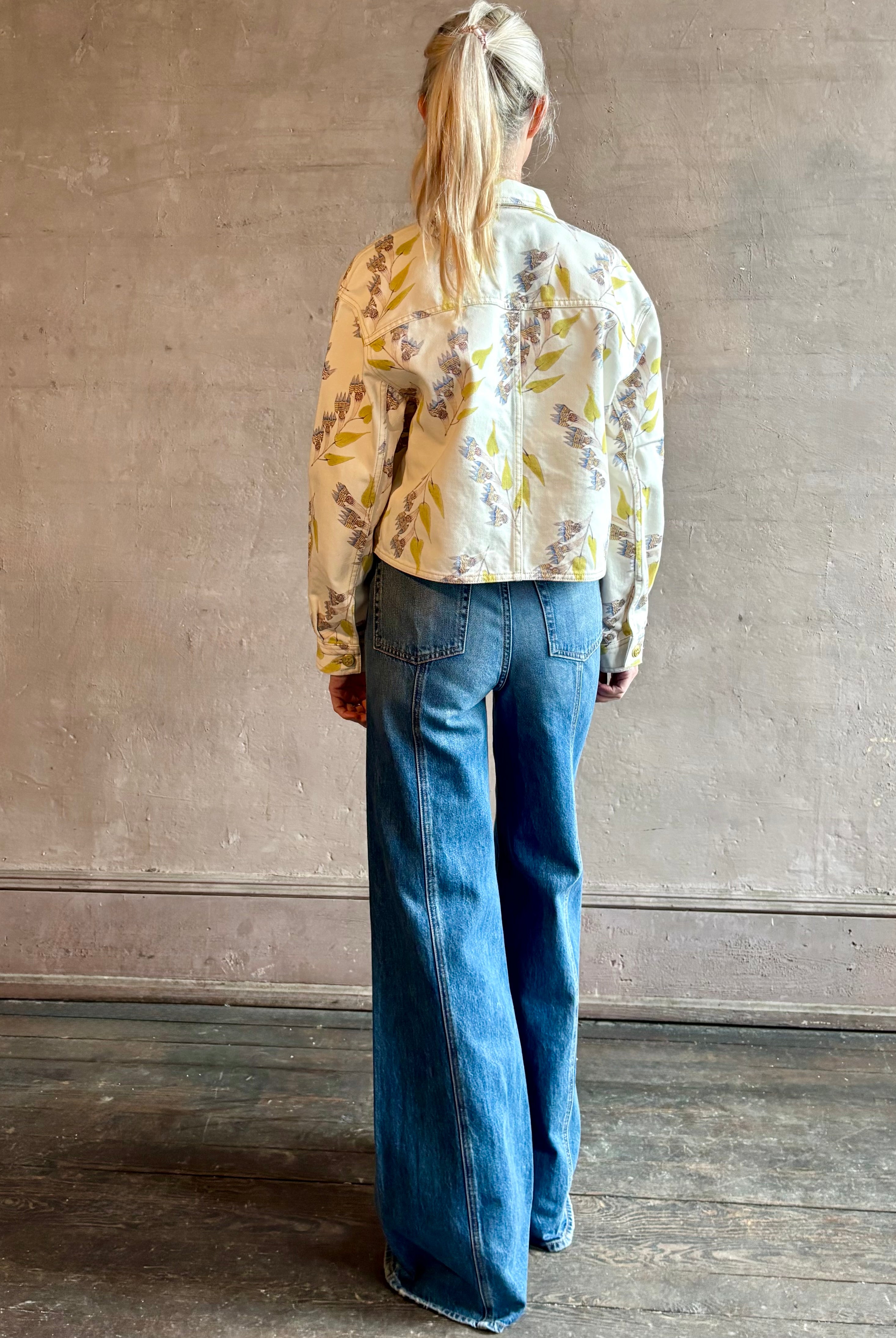 Woman wearing designer ULLA JOHNSON Bobbi denim Jacket in an artisan collaboration print Infinite Flower