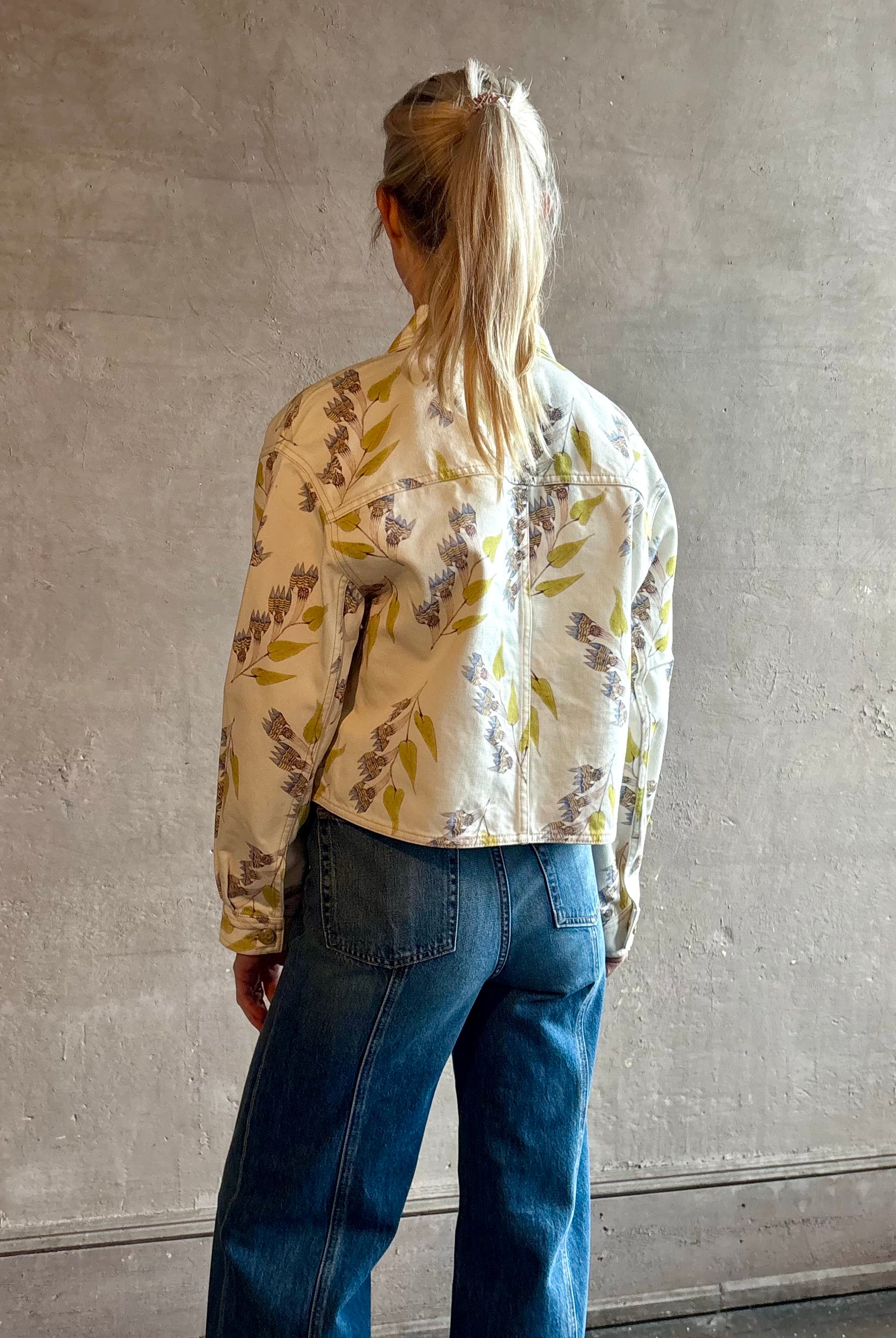 Woman wearing designer ULLA JOHNSON Bobbi denim Jacket in an artisan collaboration print Infinite Flower