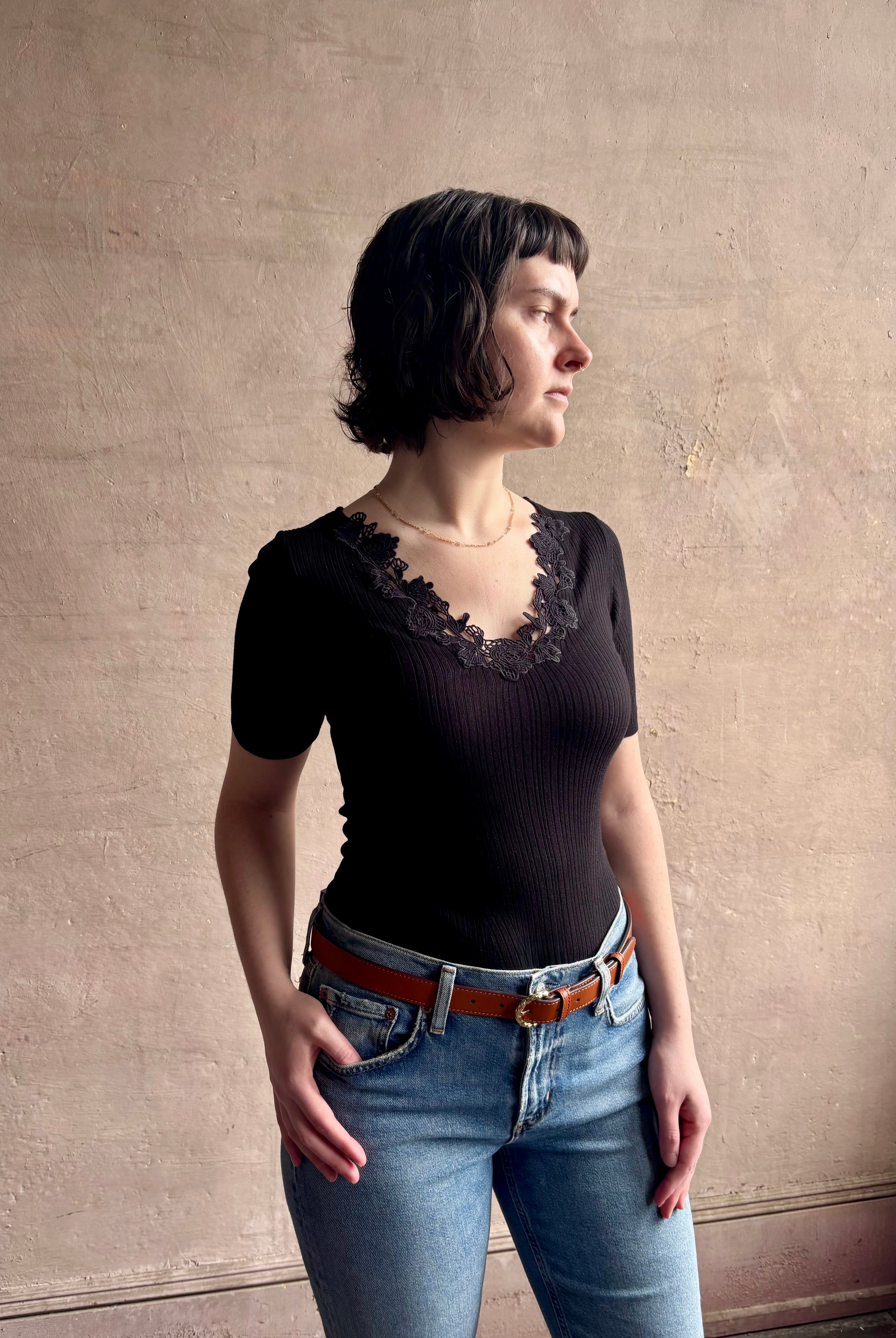 Woman wearing the Celeste Short Sleeve Knit Top with Lace from Ulla Johnson with cotton lace lined v- neck, short sleeves and fitted body