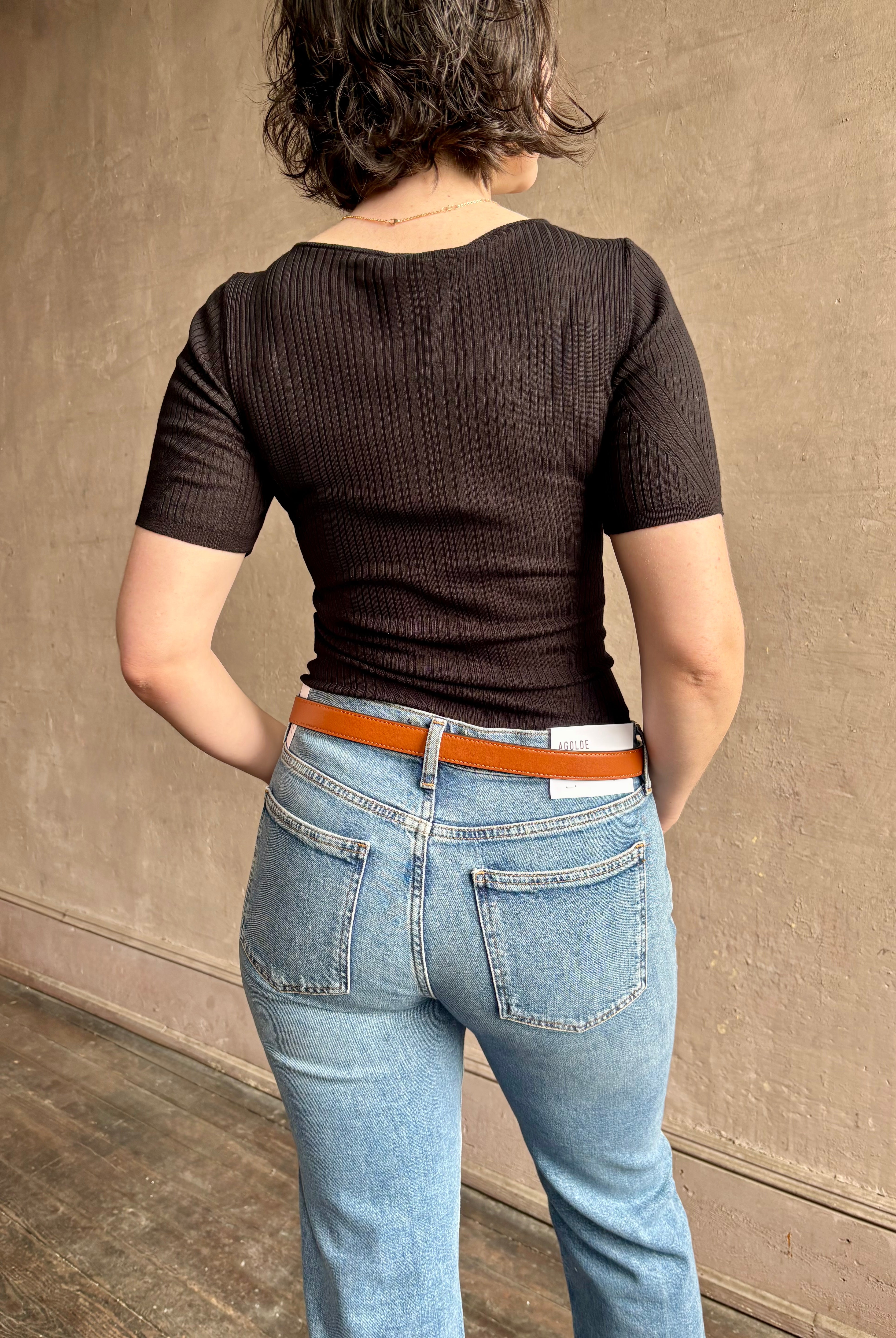 Woman wearing the Celeste Short Sleeve Knit Top with Lace from Ulla Johnson with cotton lace lined v- neck, short sleeves and fitted body