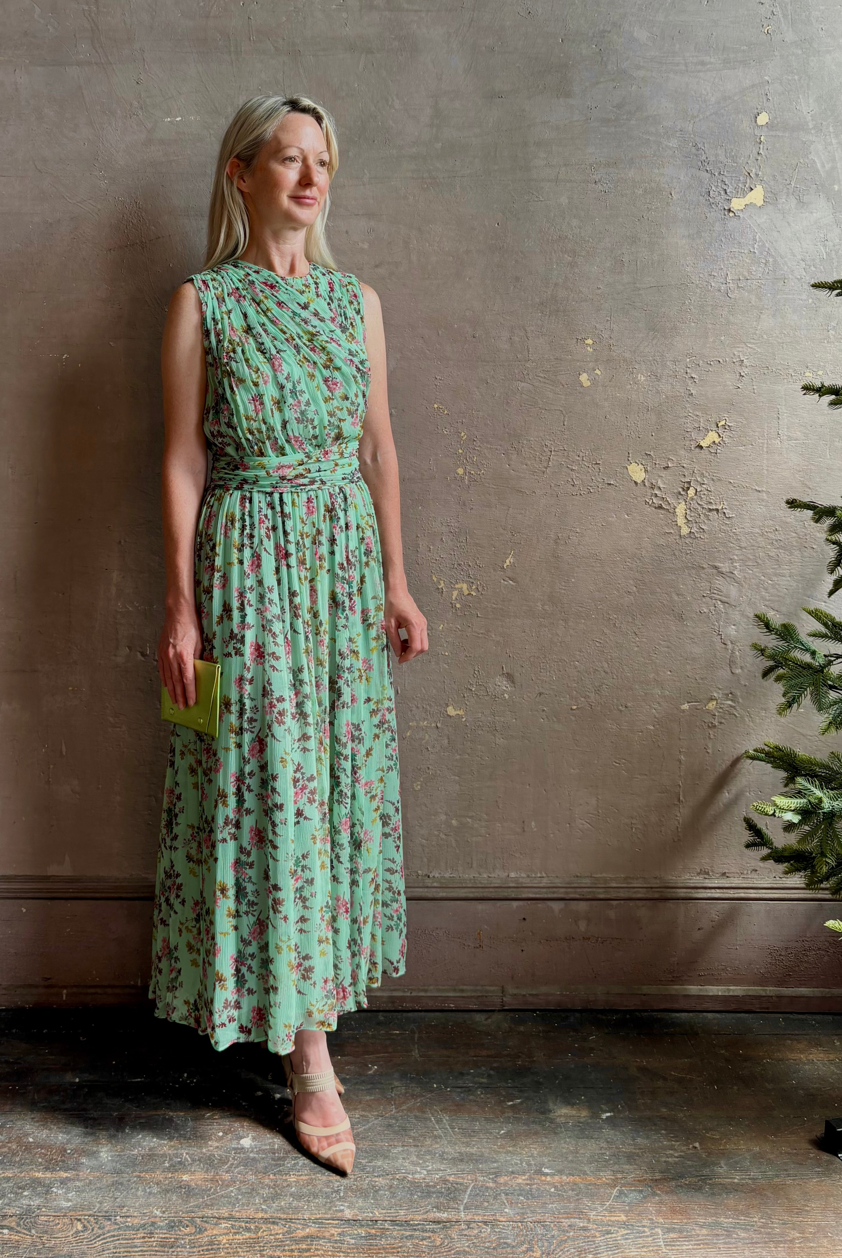 Mature woman wearing women's designer celestina silk maxi dress rendered in a mint green ground adorned with delicate brown and pink florals from Ulla Johnson that is sleevesless with gathered fabric bodice and waistband