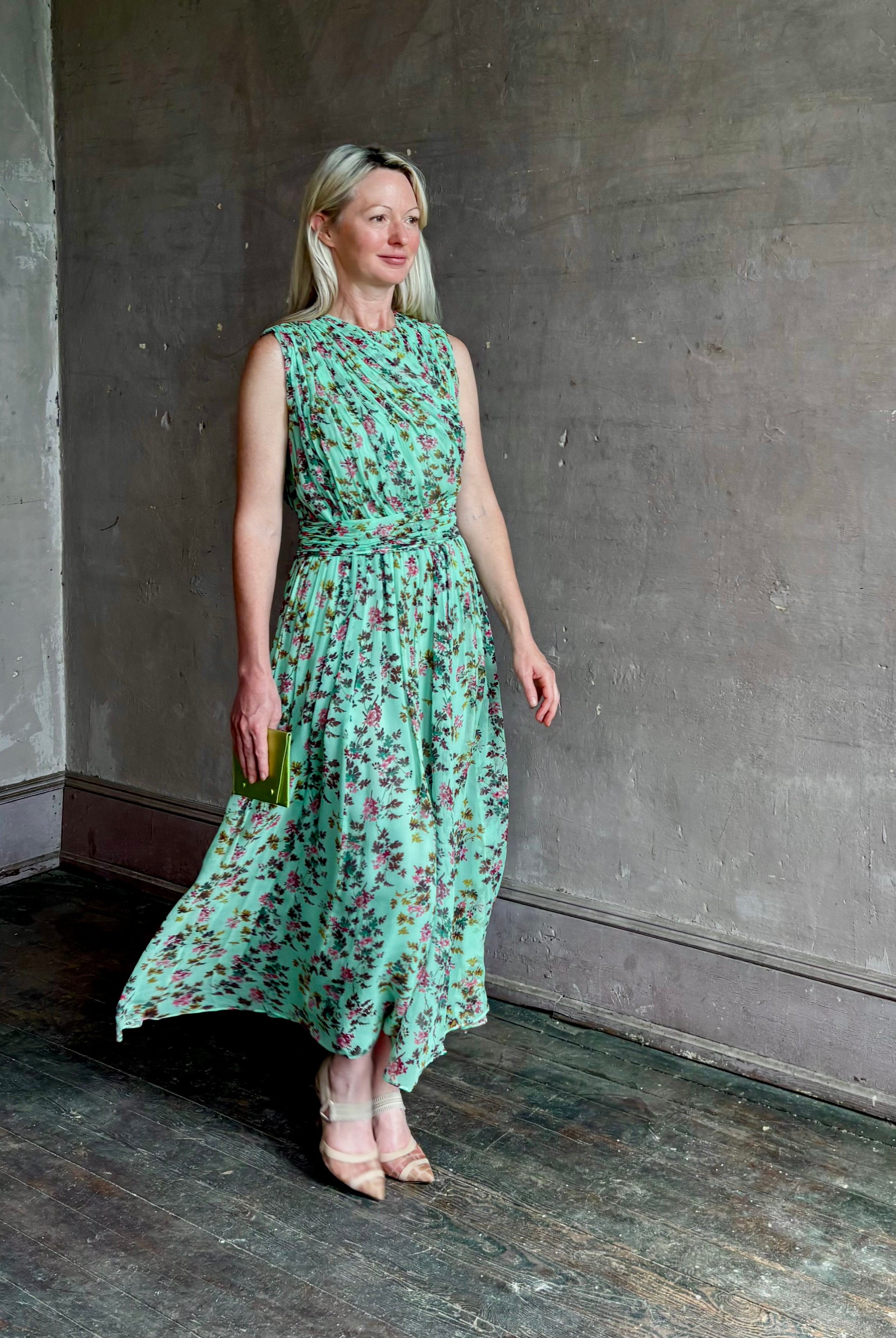 Mature woman wearing women's designer celestina silk maxi dress rendered in a mint green ground adorned with delicate brown and pink florals from Ulla Johnson that is sleevesless with gathered fabric bodice and waistband