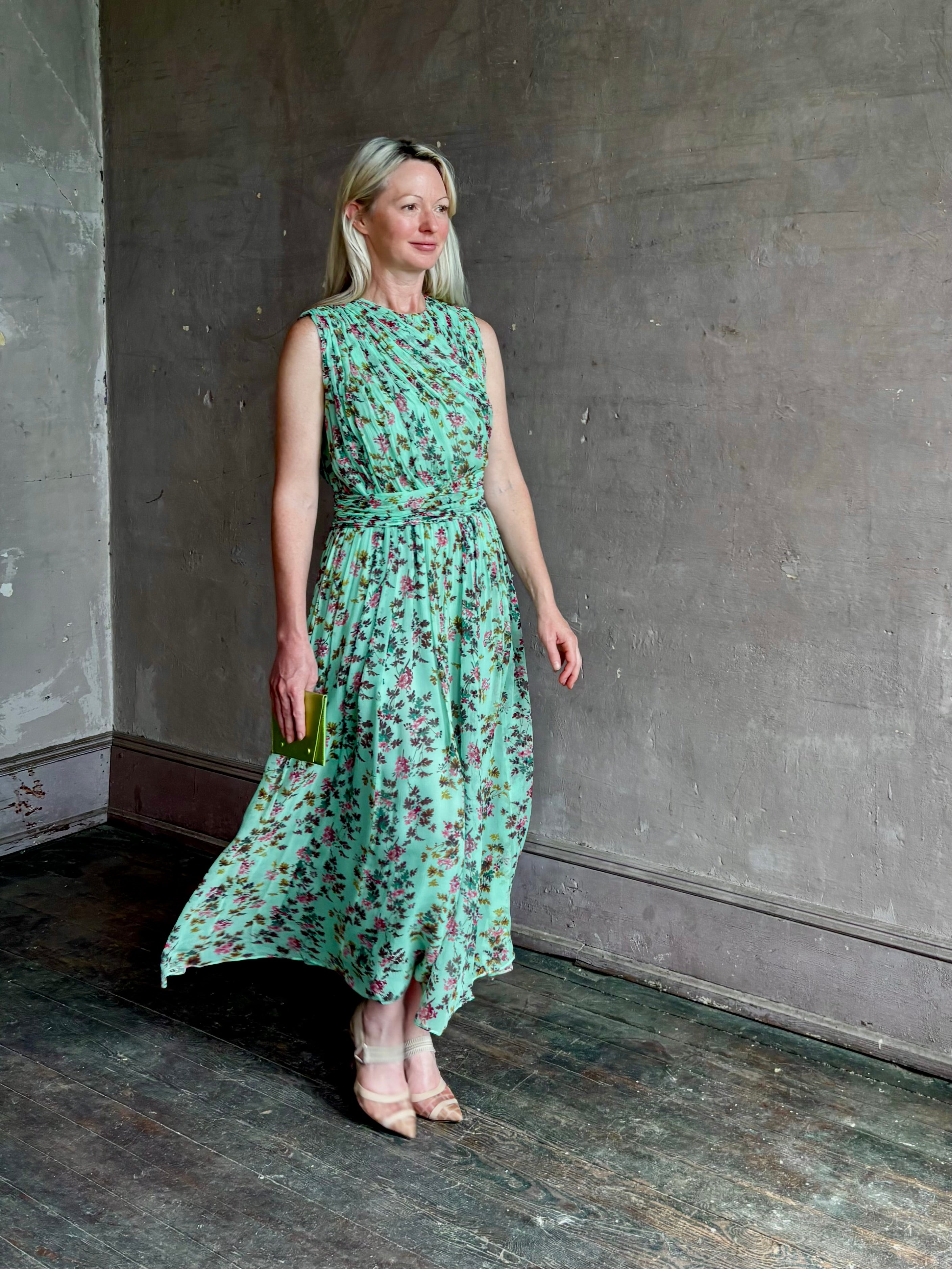 Mature woman wearing women's designer celestina silk maxi dress rendered in a mint green ground adorned with delicate brown and pink florals from Ulla Johnson that is sleevesless with gathered fabric bodice and waistband
