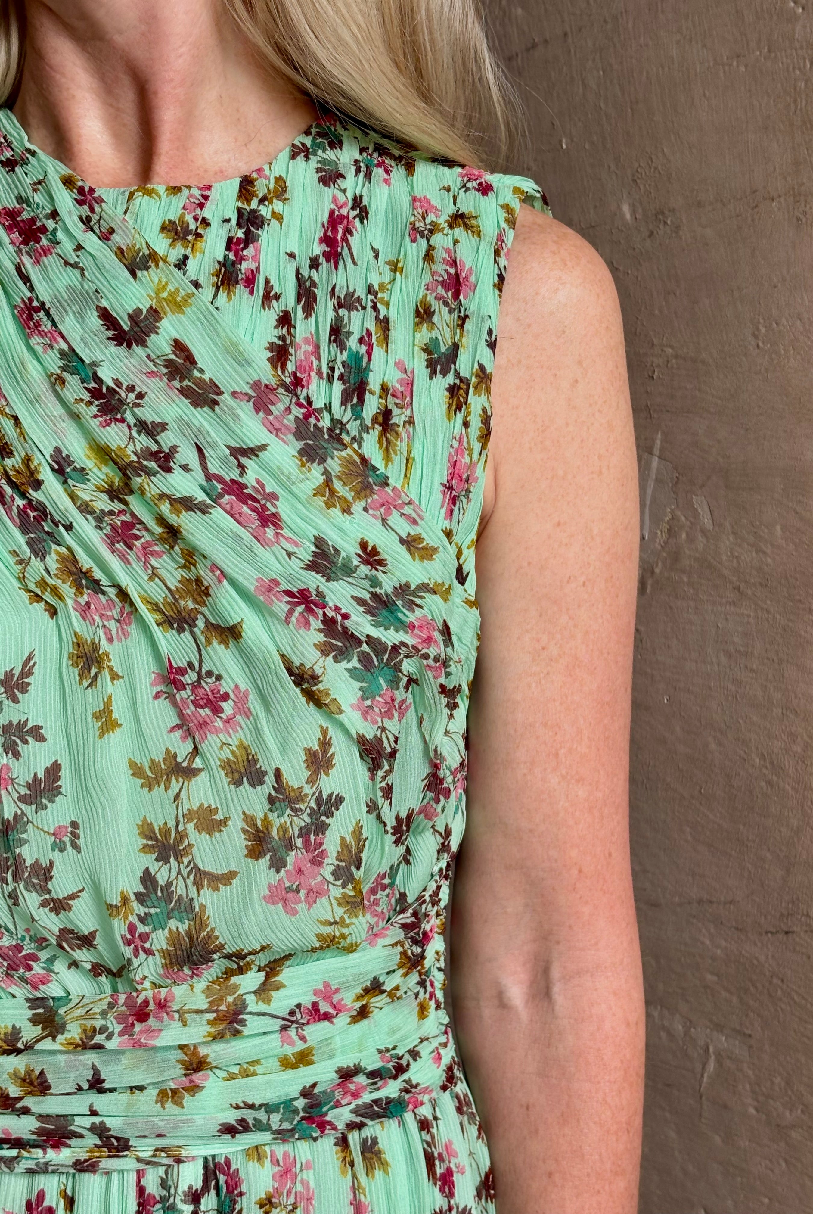 Mature woman wearing women's designer celestina silk maxi dress rendered in a mint green ground adorned with delicate brown and pink florals from Ulla Johnson that is sleevesless with gathered fabric bodice and waistband