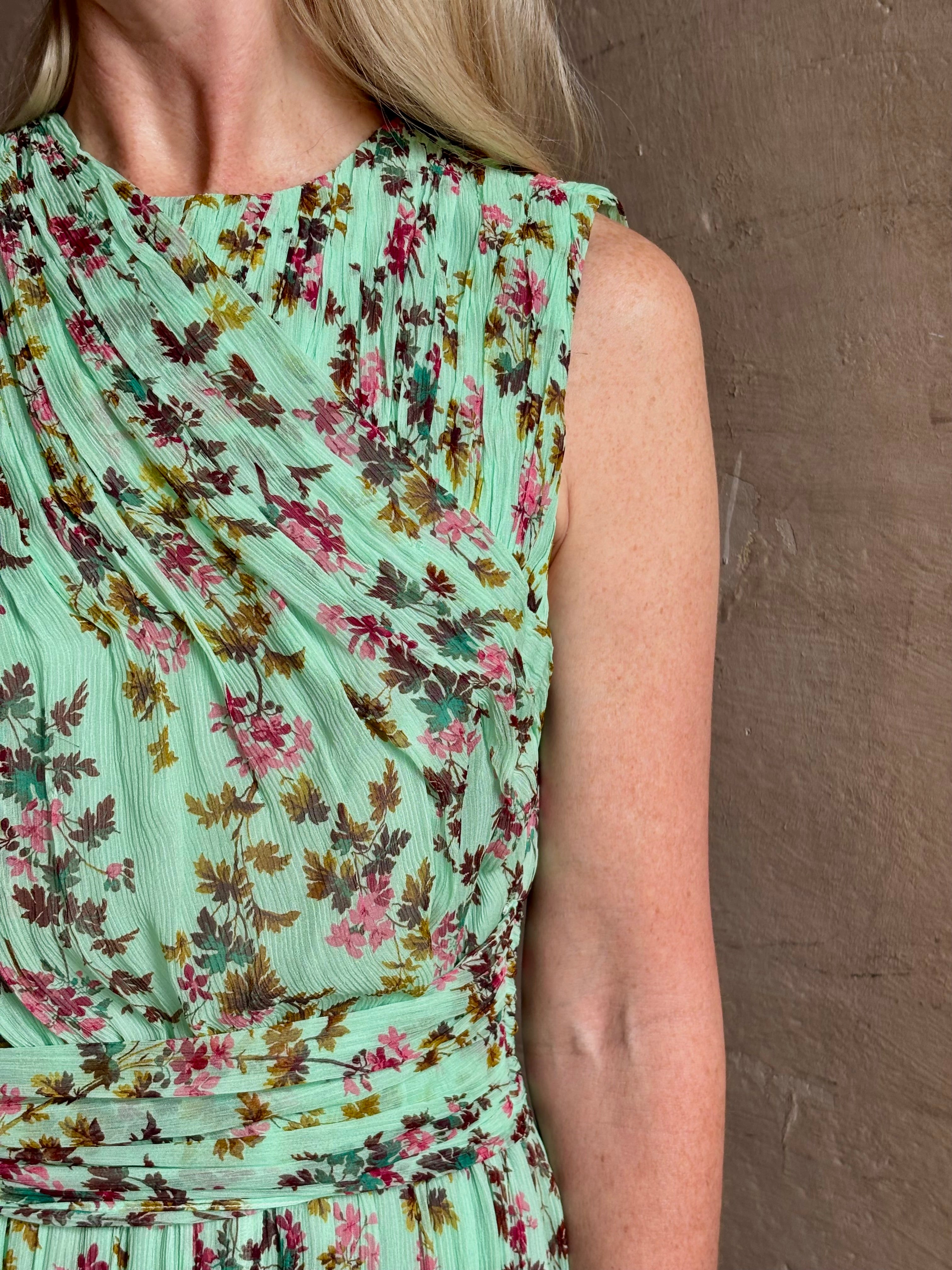 Mature woman wearing women's designer celestina silk maxi dress rendered in a mint green ground adorned with delicate brown and pink florals from Ulla Johnson that is sleevesless with gathered fabric bodice and waistband