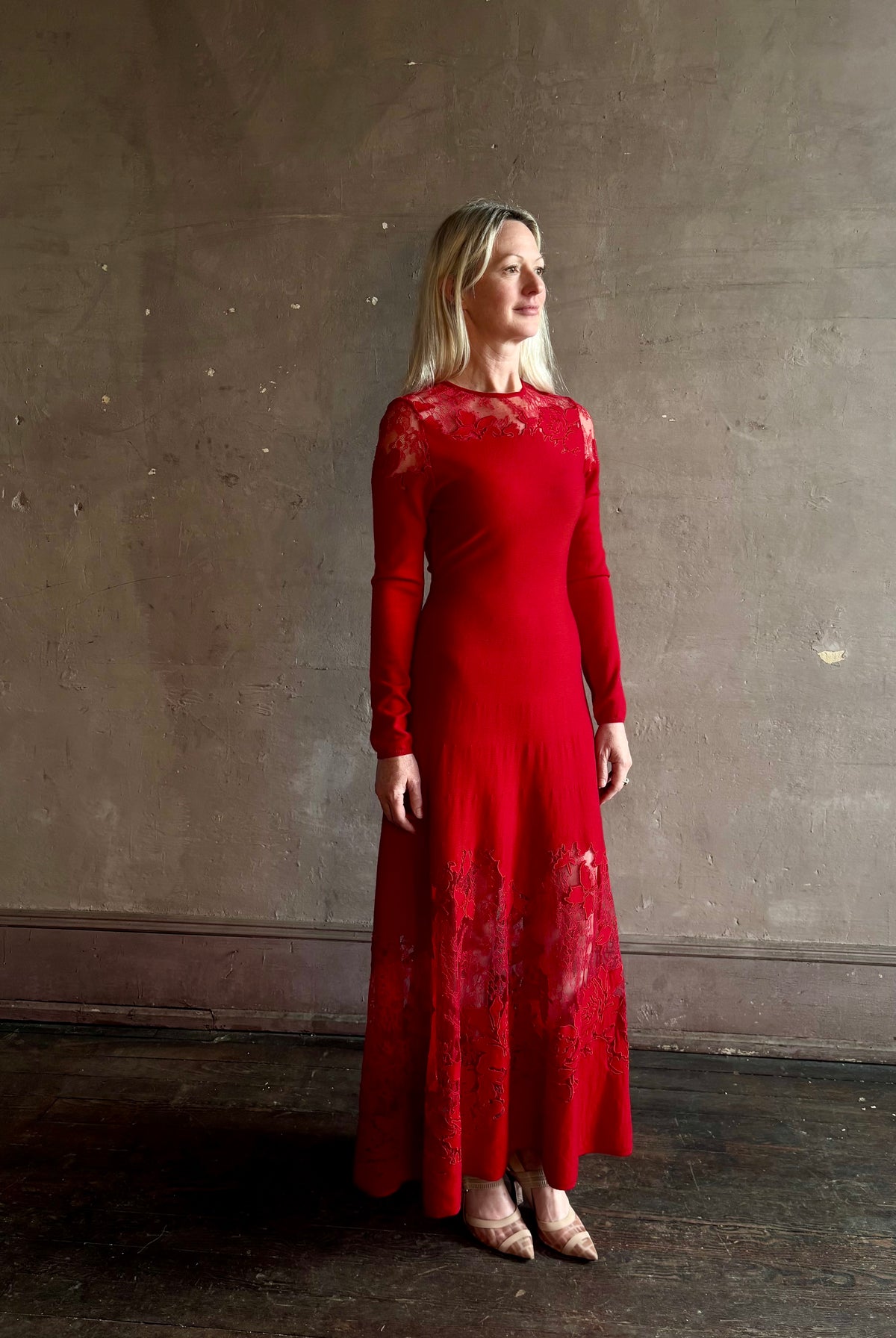 Mature woman wearing designer Ulla Johnson's Clemence LS Lace Dress in Cerise red virgin wool knit with delicate lace at the bodice and hemline striking sophisticated occasion elegance