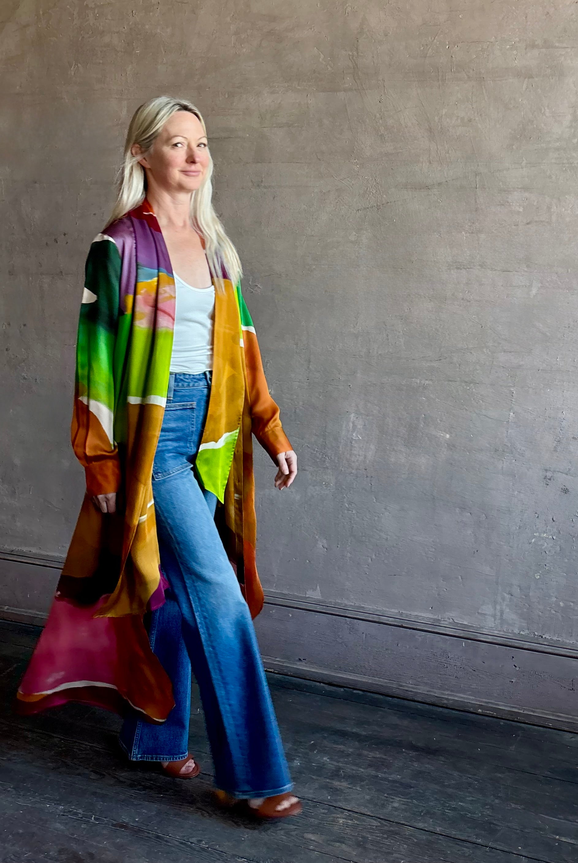 Woman wearing the Critique Long Sleeve fluid Silk maxi Dress from Ulla Johnson in wearable art abstract print via a collaboration with American painter Helen Frankenthaler