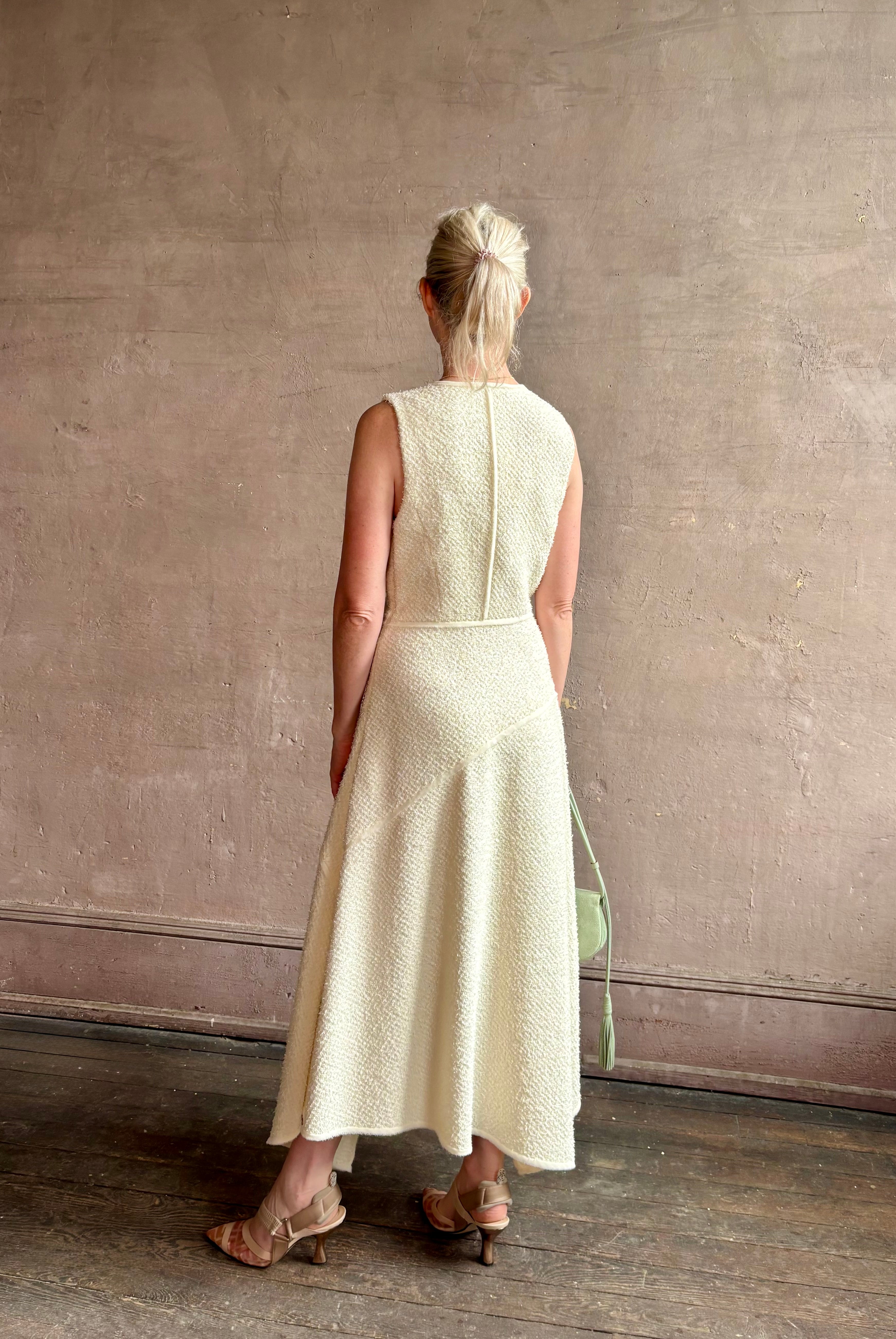 Woman wearing luxury Ulla Johnson Florence Dress concealed zip closure sleeveless fit and flare design