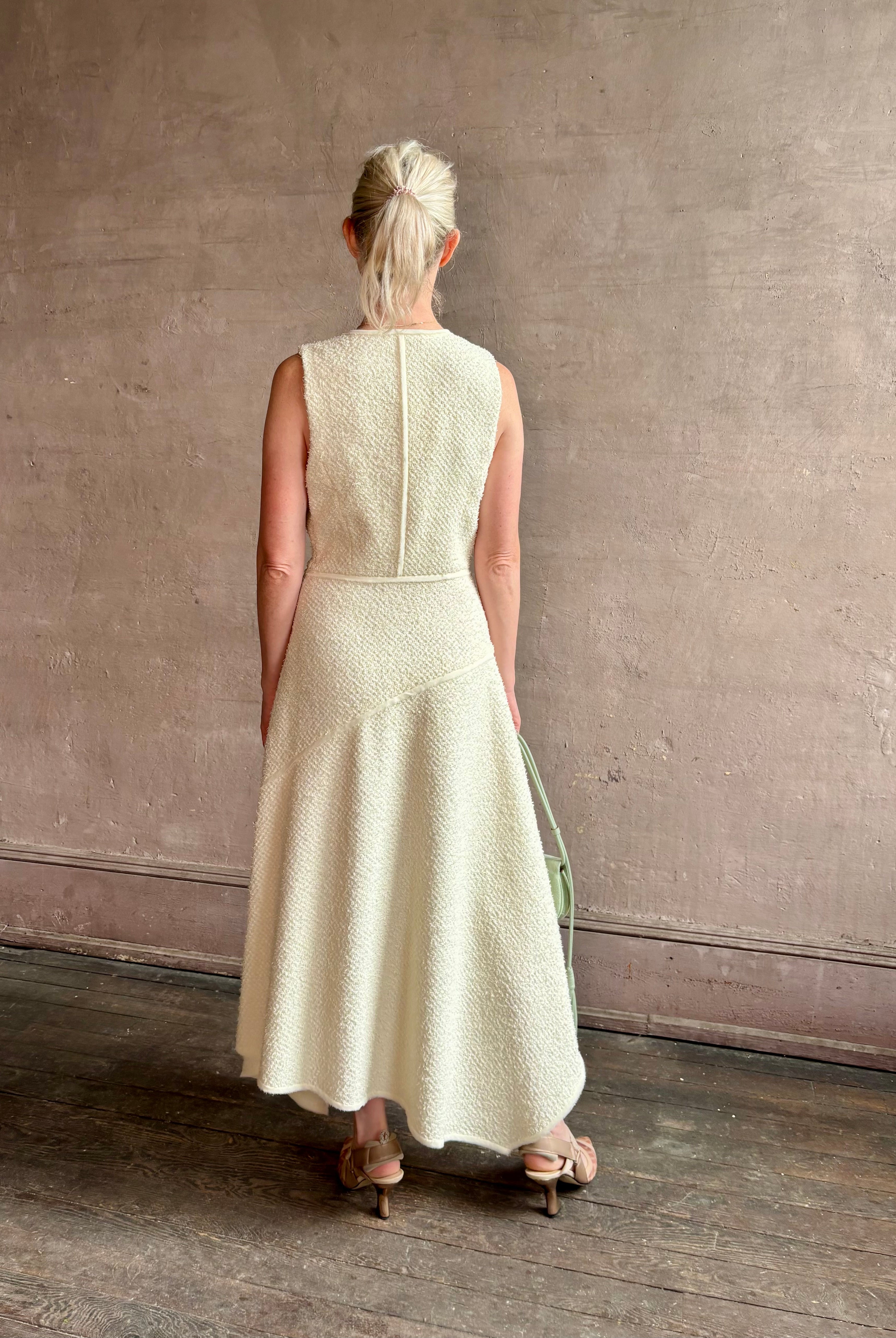 Woman wearing luxury Ulla Johnson Florence Dress concealed zip closure sleeveless fit and flare design