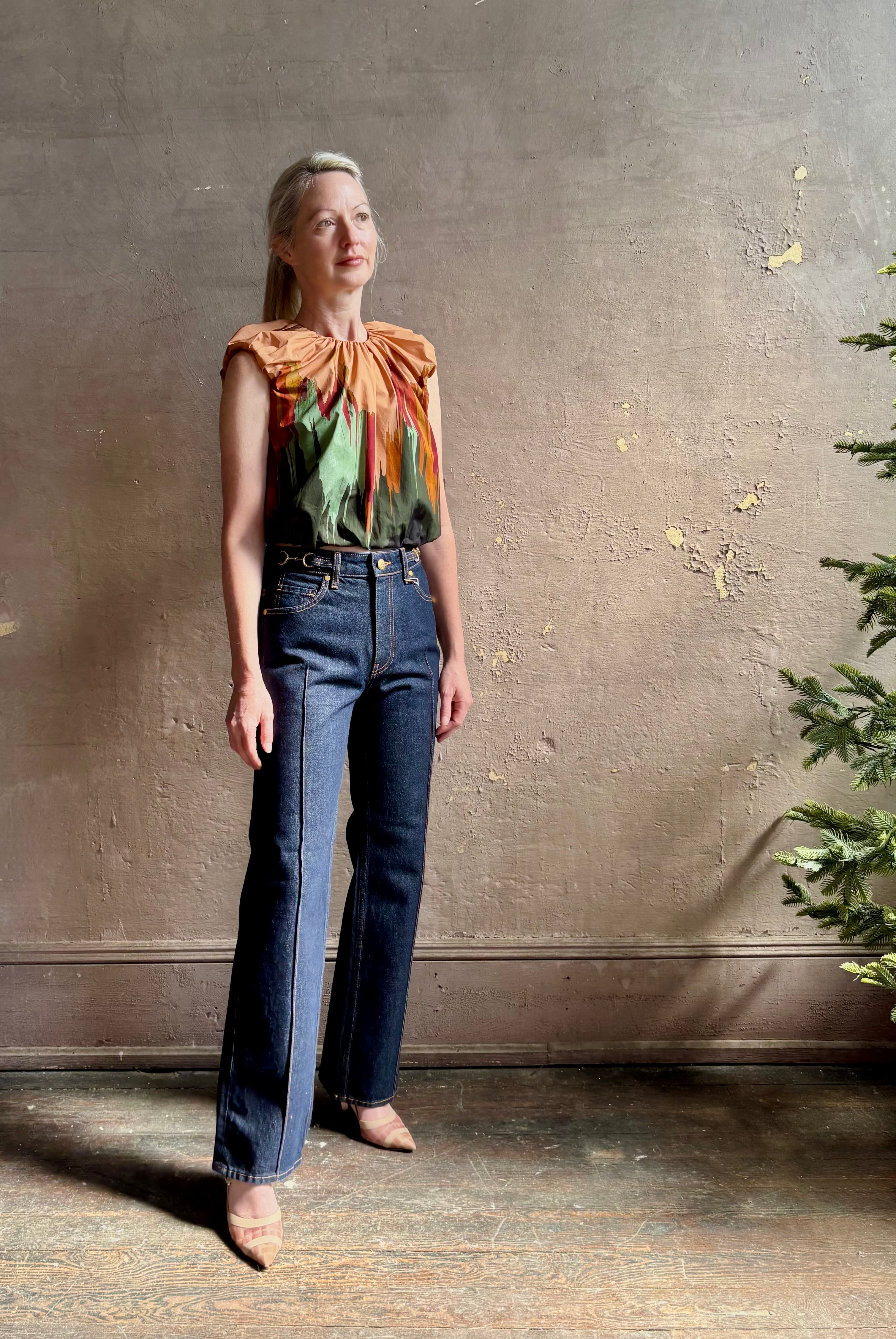 Mature woman wearing Women's designer Gracie sleeveless Cotton Top from Ulla Johnson rendered in a rich abstract Agate print composed of dark green, mint green, burgundy, terra cotta, and sienna and crafted from lightweight cotton poplin