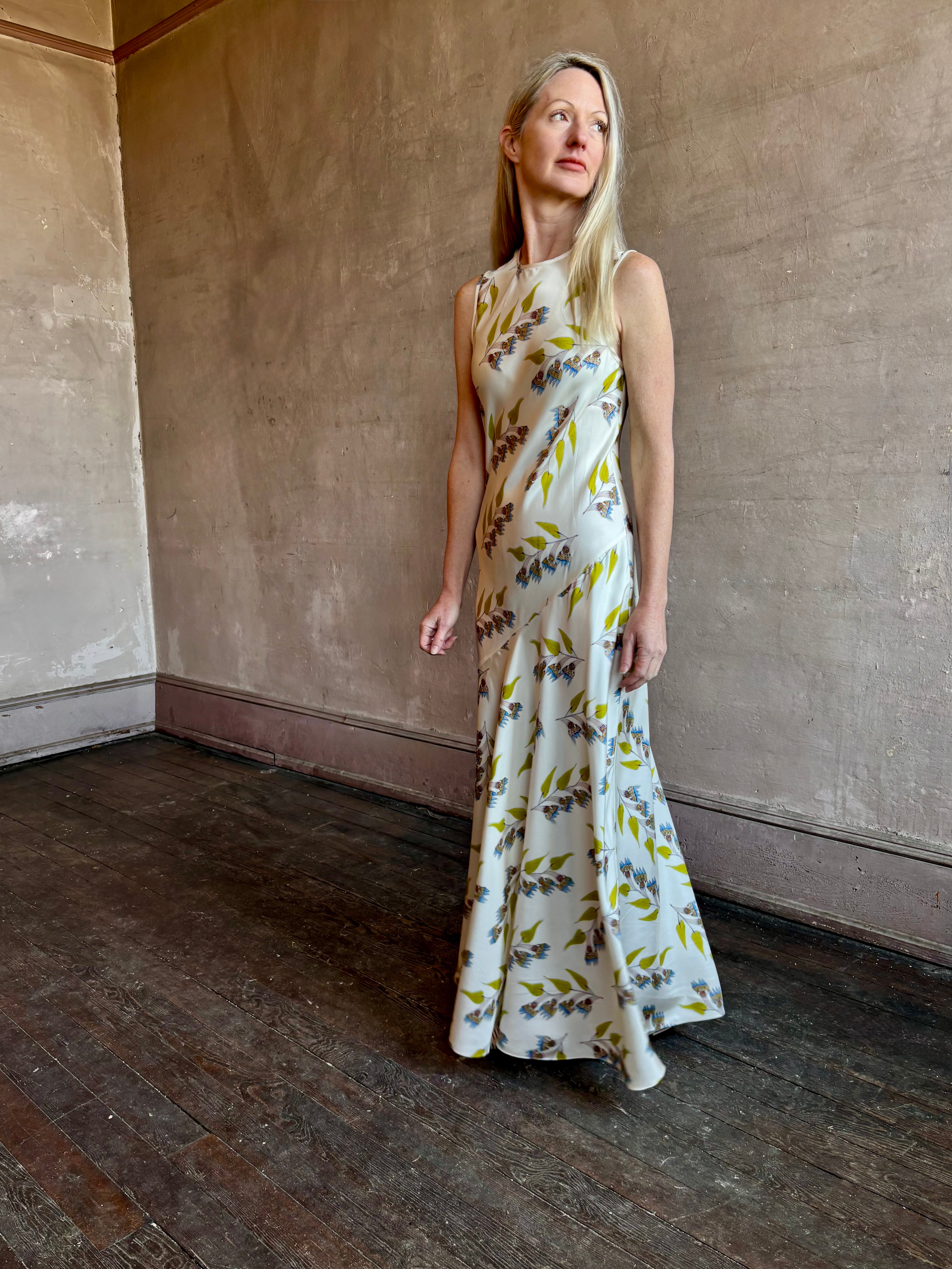 Image of mature woman wearing timeless limited edition ULLA JOHNSON Gaea maxi silk Dress with contemporary floral prints from artist Anna Zemankova