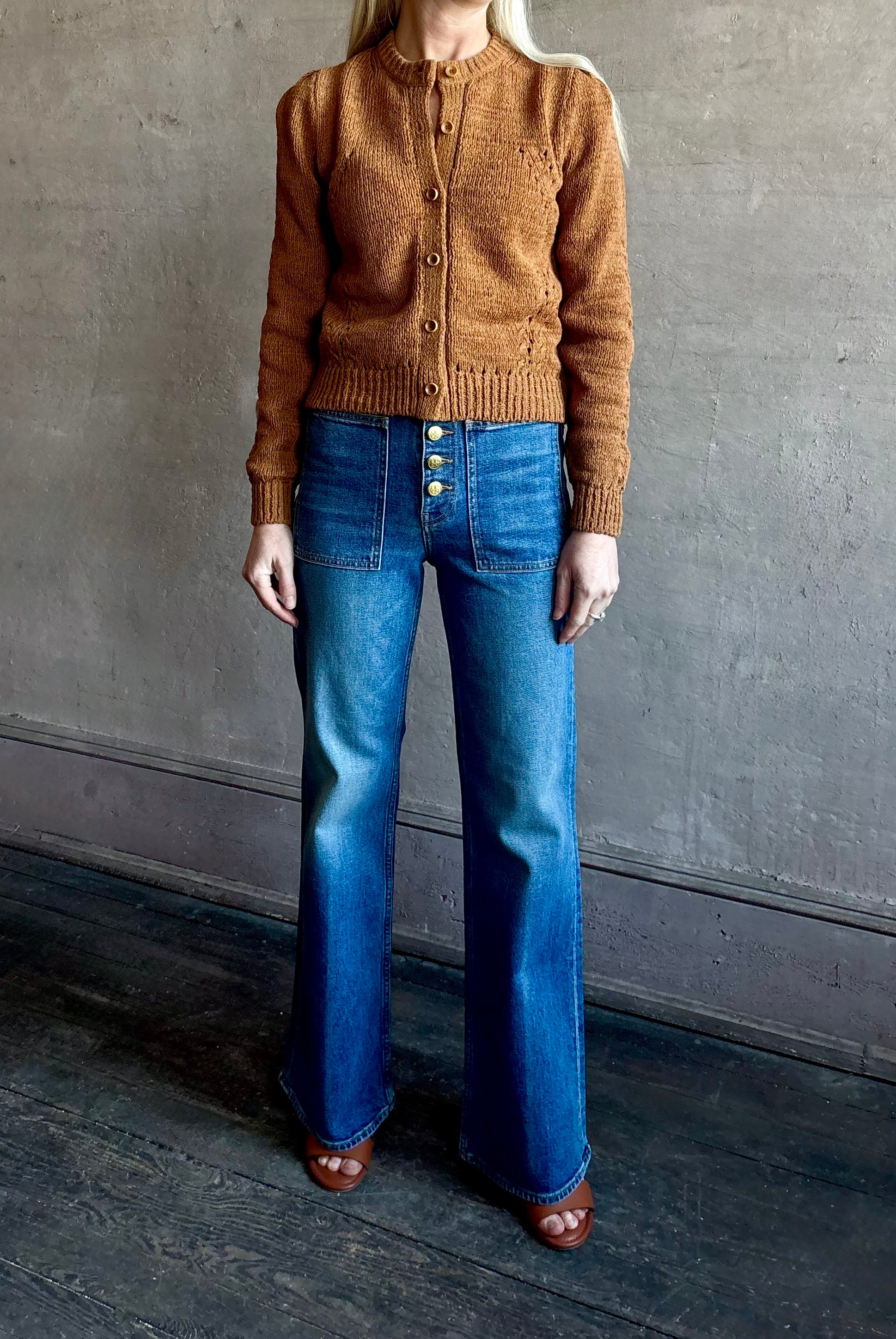 Woman wearing women's designer denim the Lou Jean from Ulla Johnson handcrafted in USA with gold buttons, front pockets and straight legs in medium wash denim